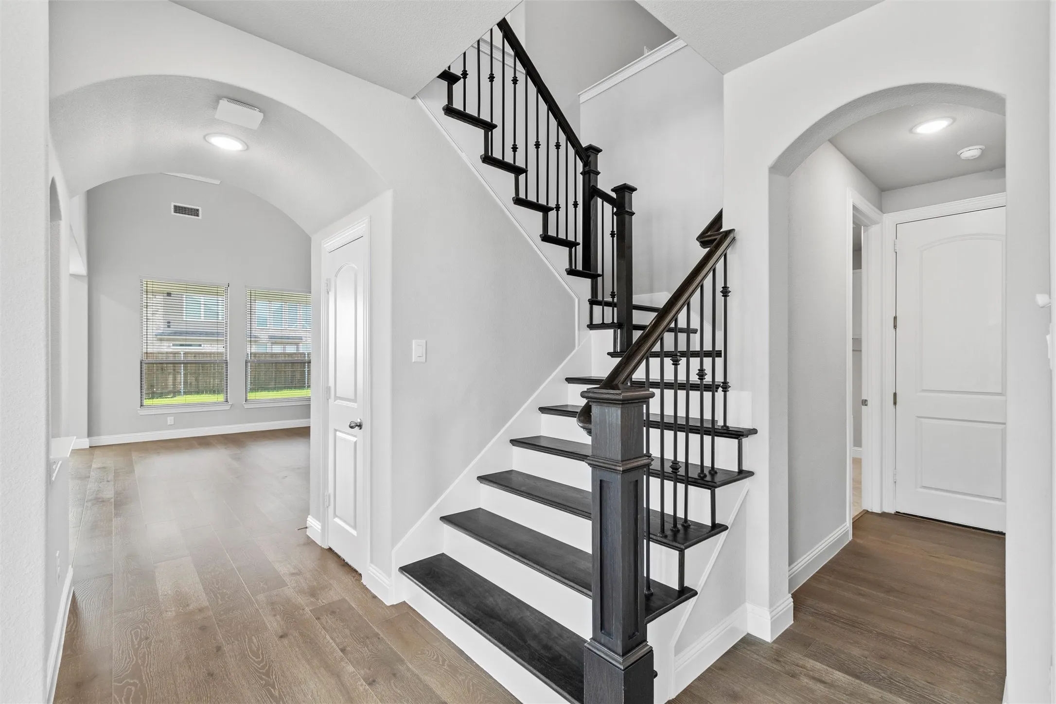 Stairs with hardwood / wood-style floors