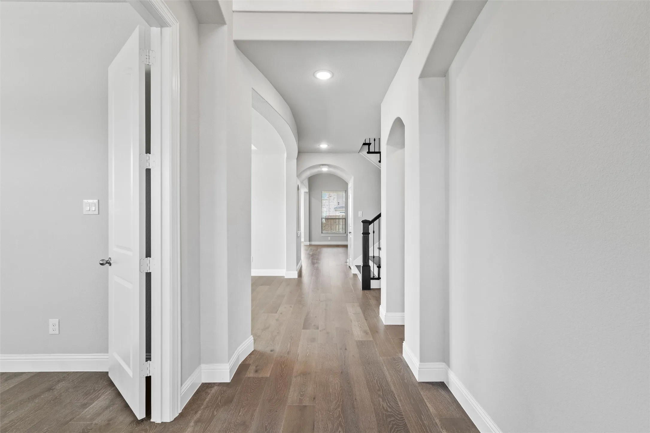 Hallway with hardwood / wood-style floors