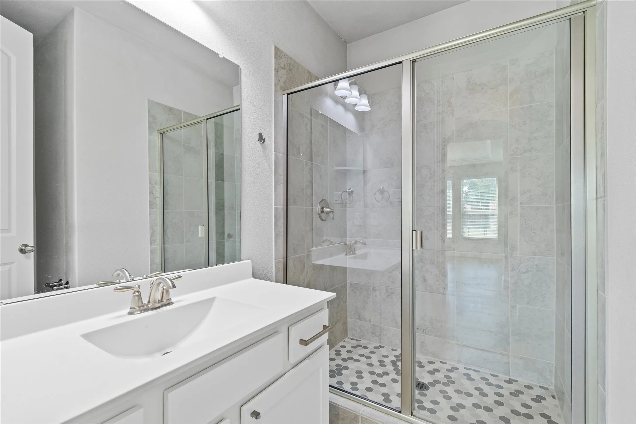 Bathroom featuring vanity and an enclosed shower