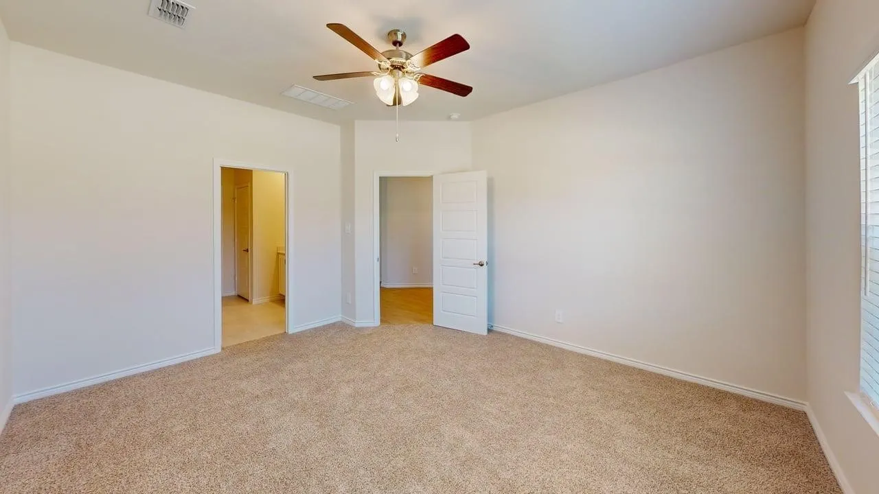 Carpeted interior room with neutral wall tones