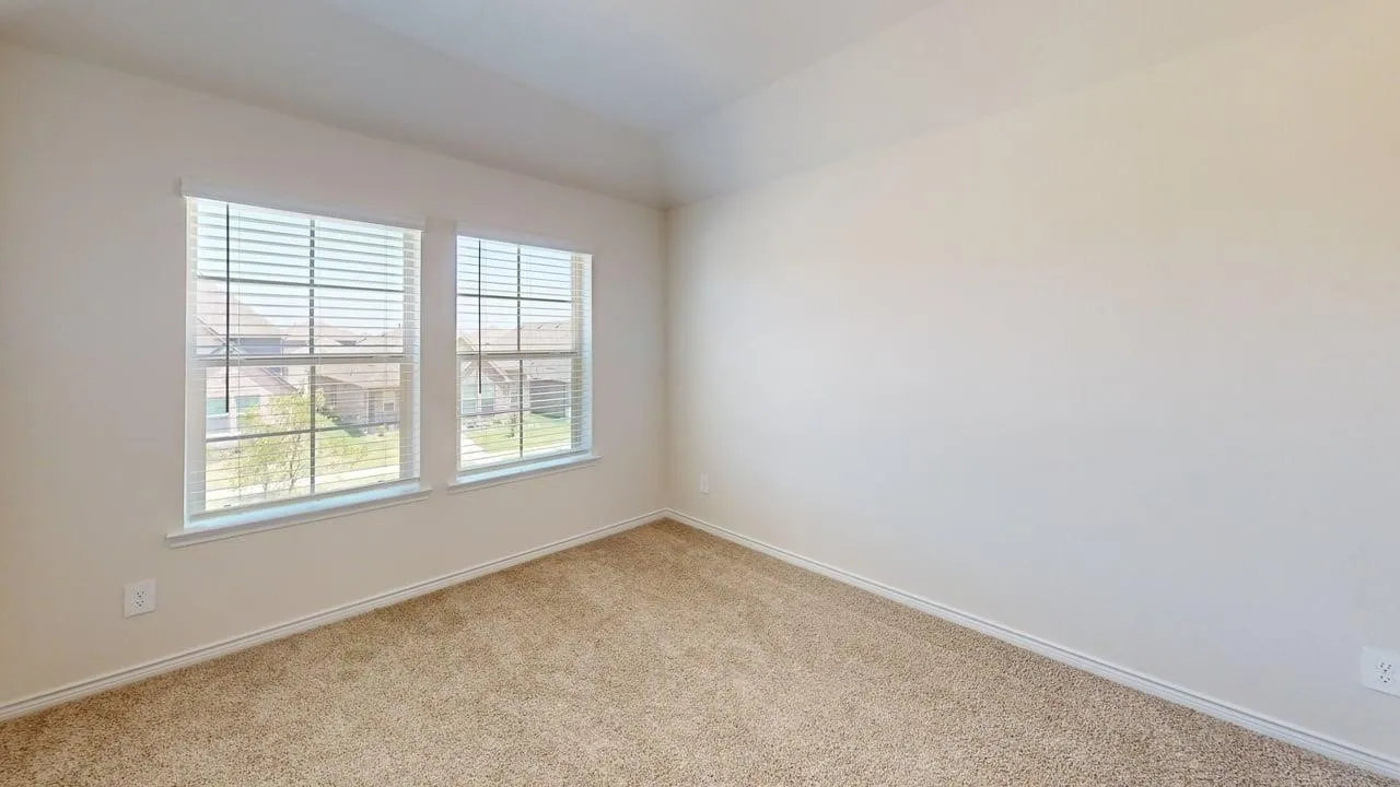 Room featuring a neutral wall color, two windows with horizontal blinds, light-colored carpeting, and white baseboards