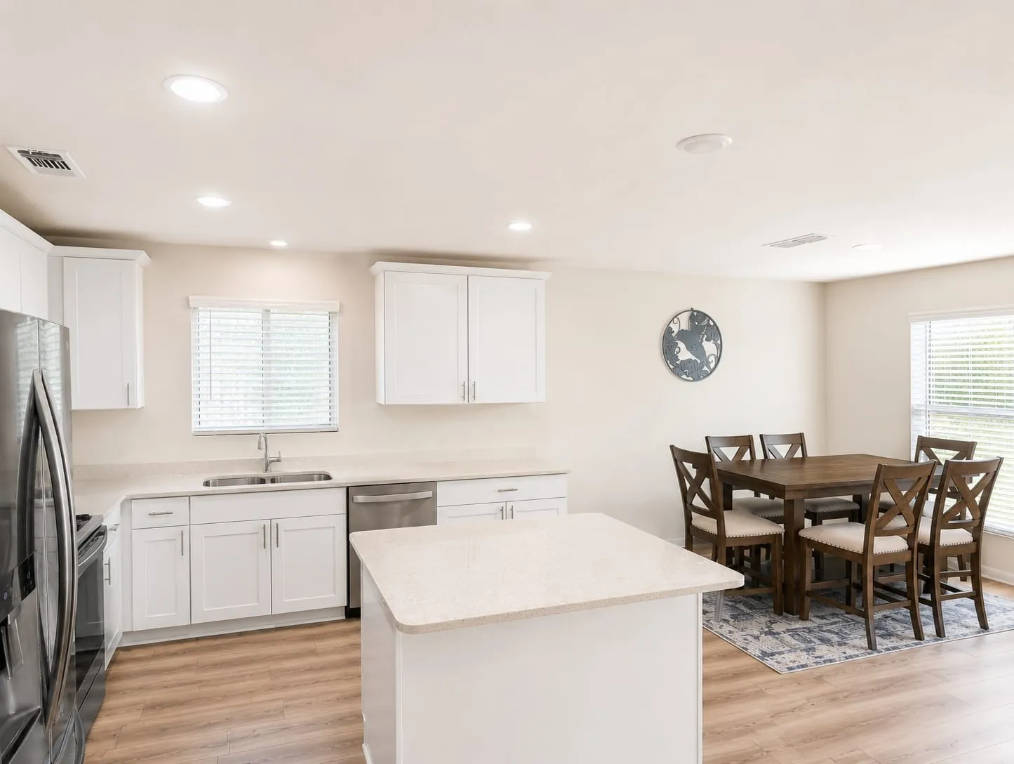 Open-concept kitchen and dining area with wood-finish flooring