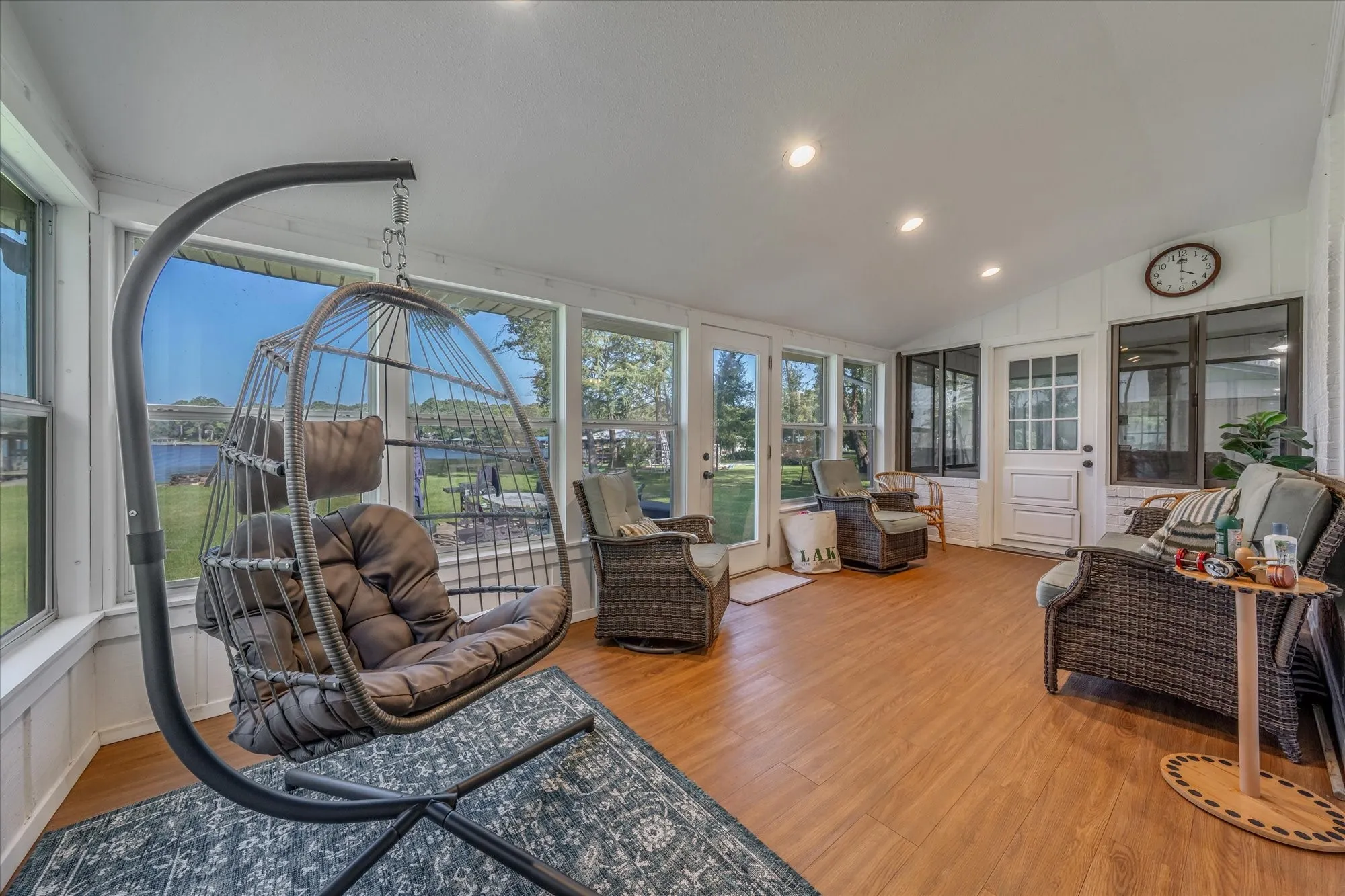 Bright sunroom featuring wood-finish flooring and extensive windows