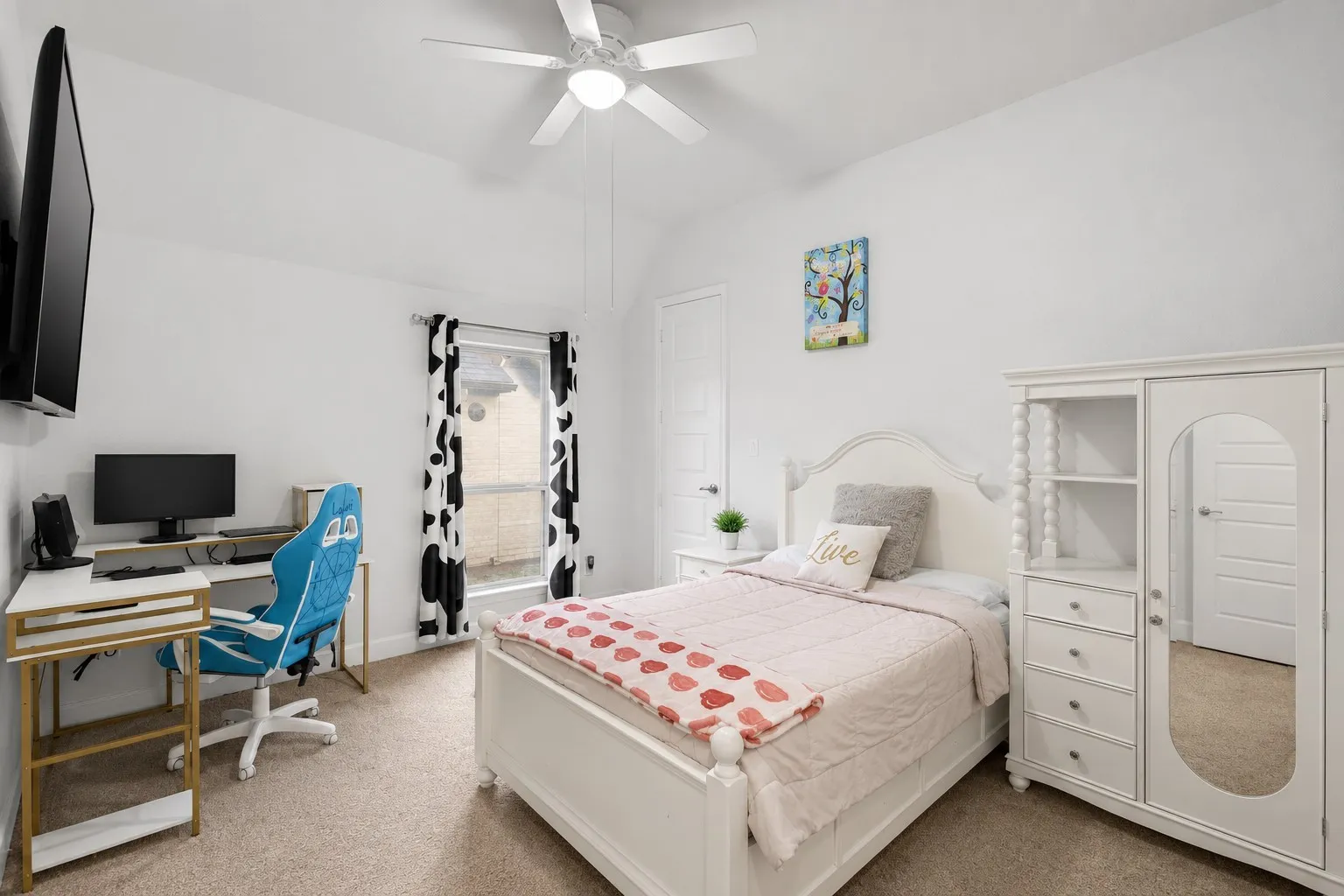 Carpeted room featuring a ceiling fan with light fixture, a window with vertical blinds, and a built-in closet with a mirrored door