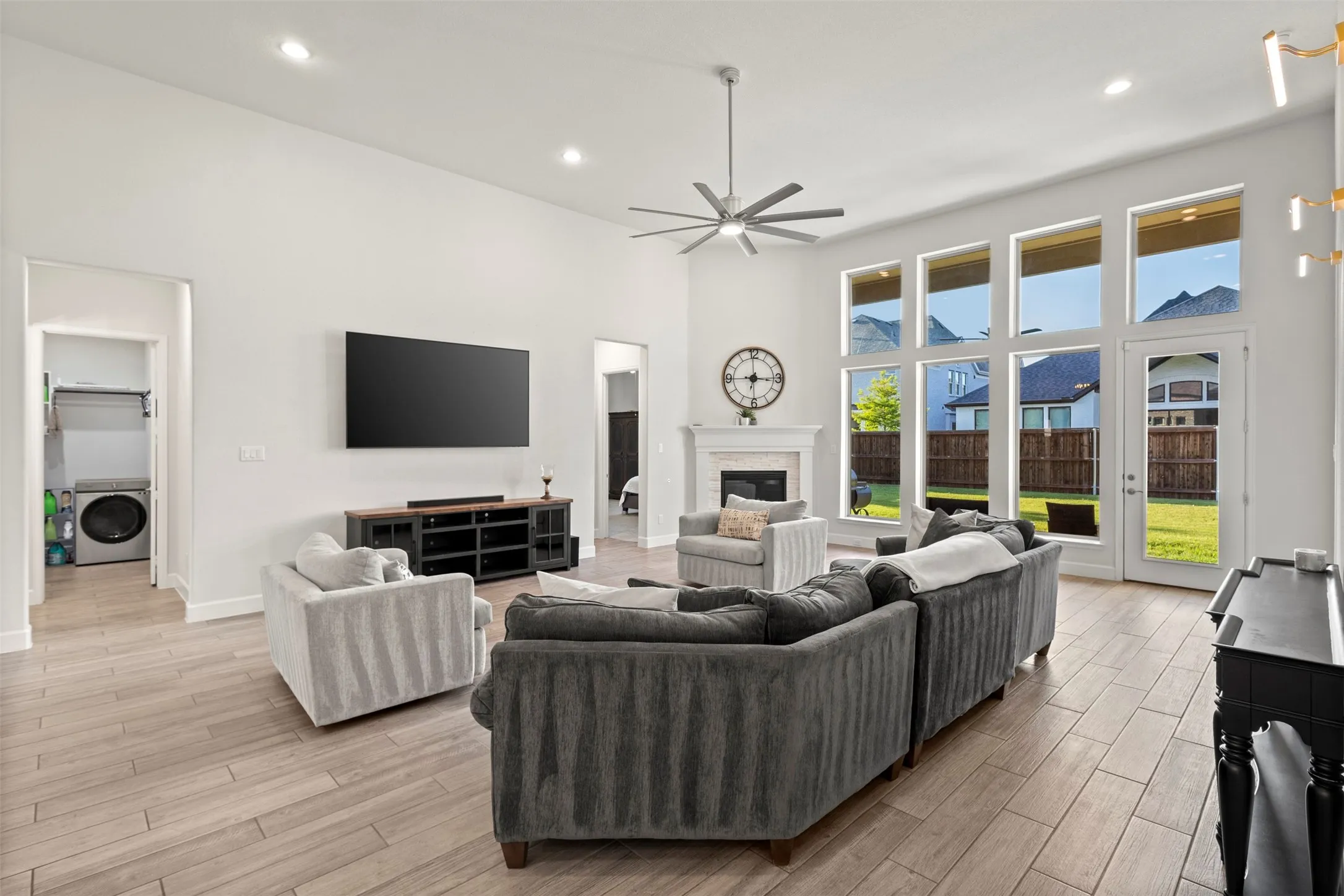 Spacious living area featuring wood-finish flooring, vaulted ceilings, and recessed lighting