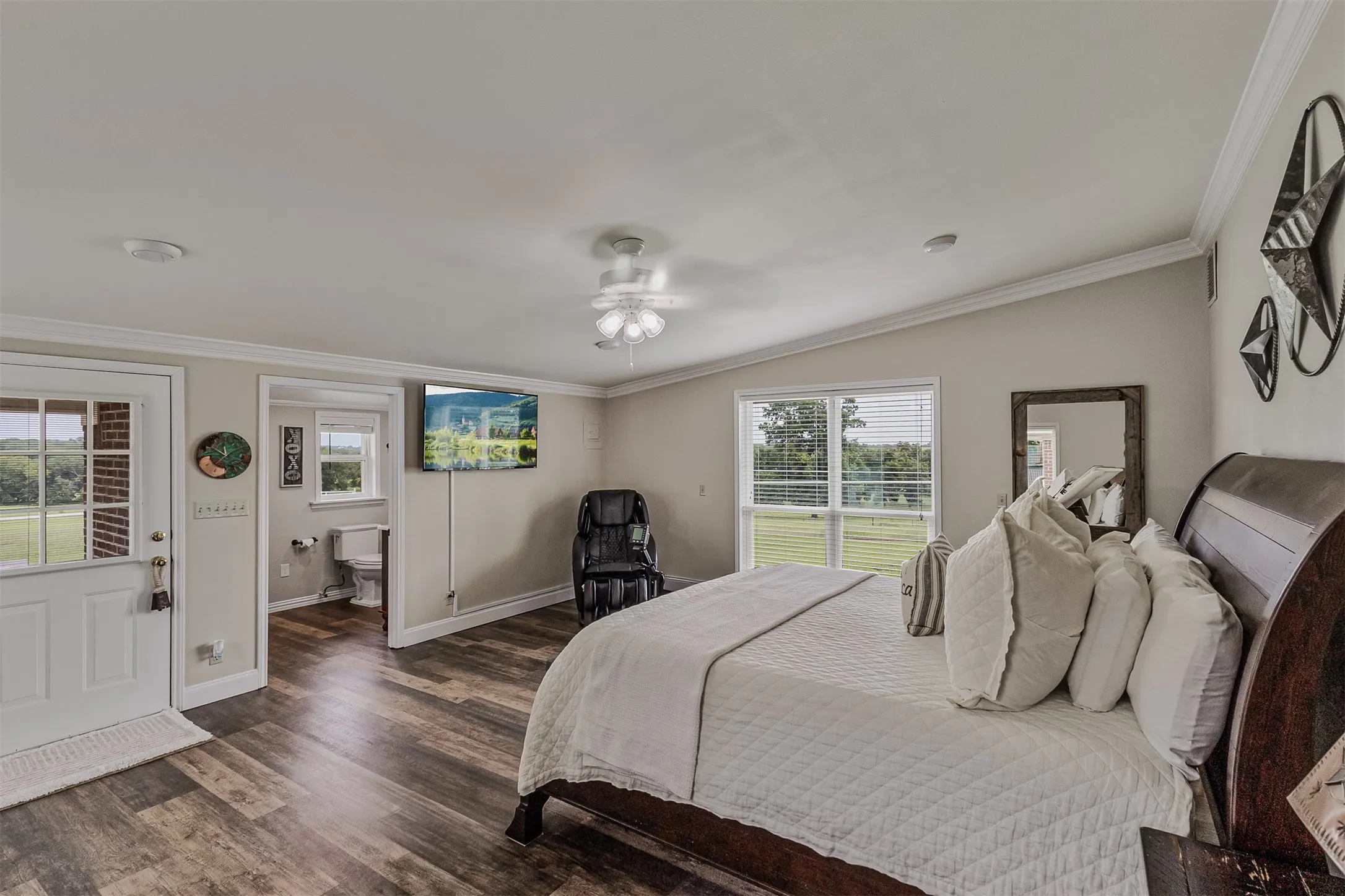 Large primary bedroom with ensuite bathroom and direct access to the outdoors of 339 Colwell Rd in Forestburg, TX