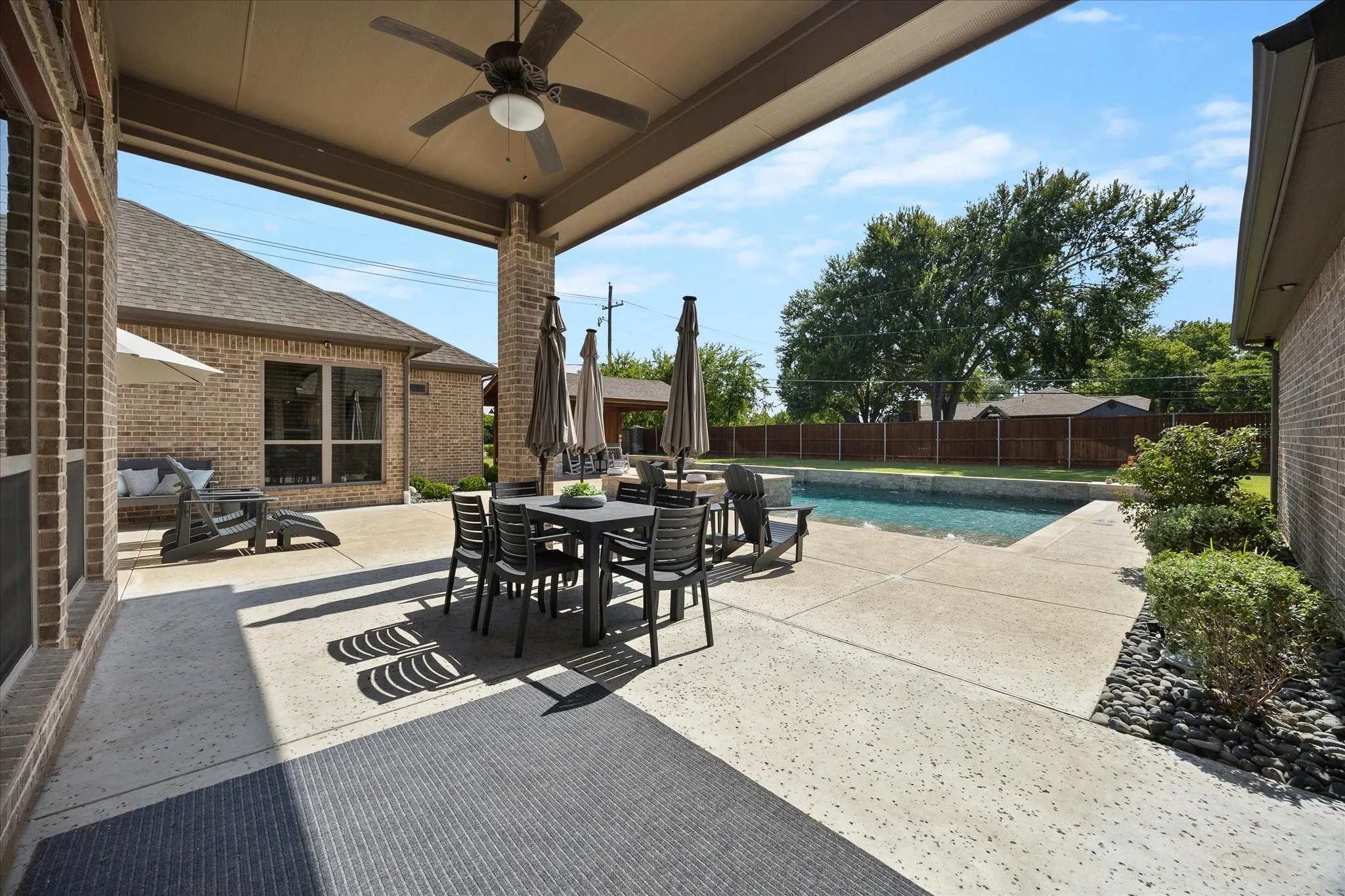 Covered patio overlooking pool is a must for outdoor entertaining!