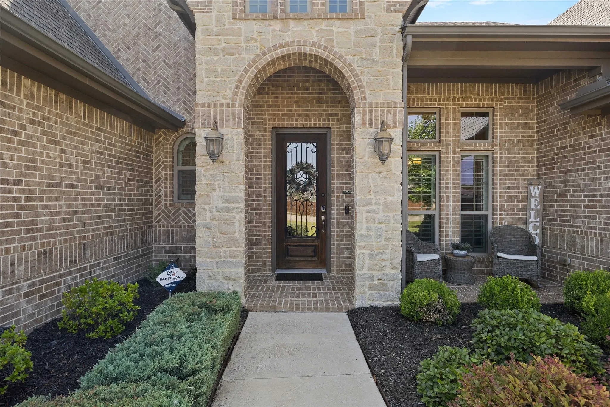Covered porch and lush landscaping beyond your arrival!