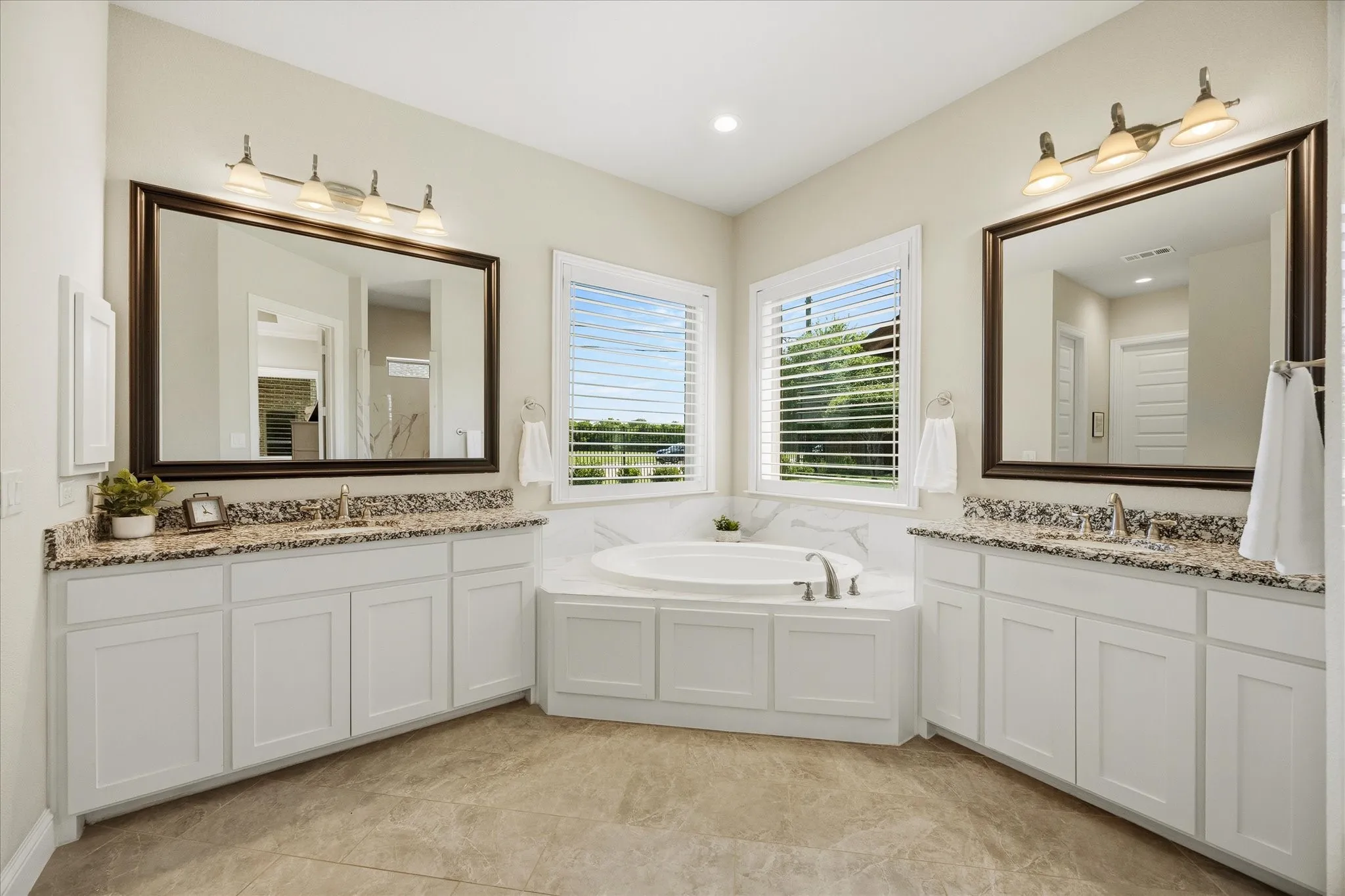 Spa style master bath includes his and her vanities and soaking tub!