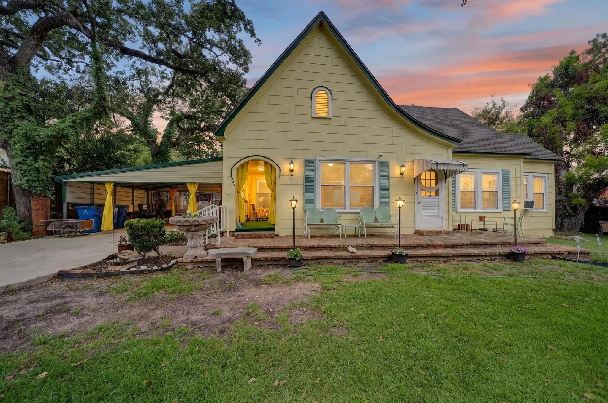 Charming yellow exterior with green trim and light blue shutters