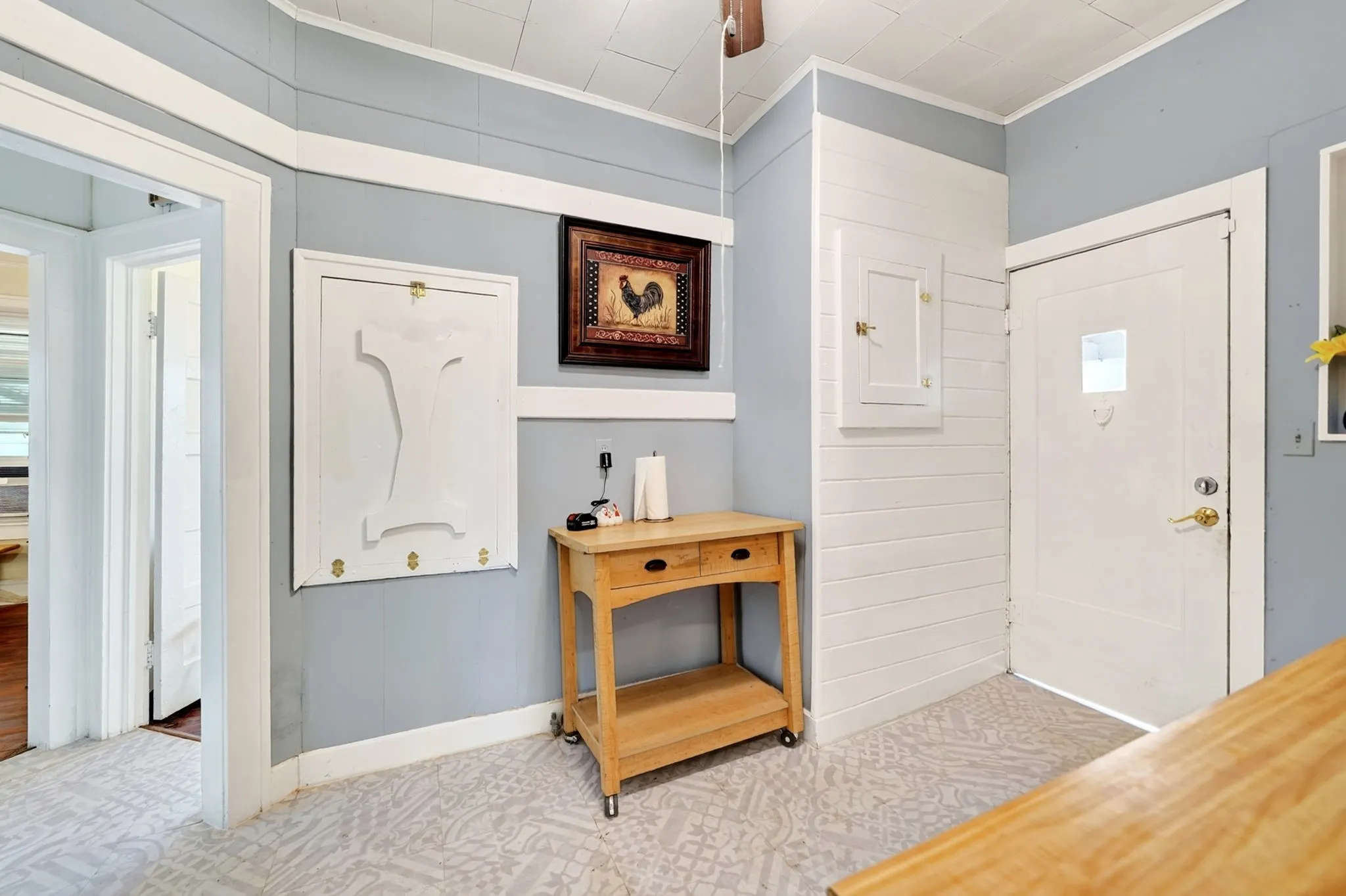 Light blue walls with white trim and shiplap accent wall