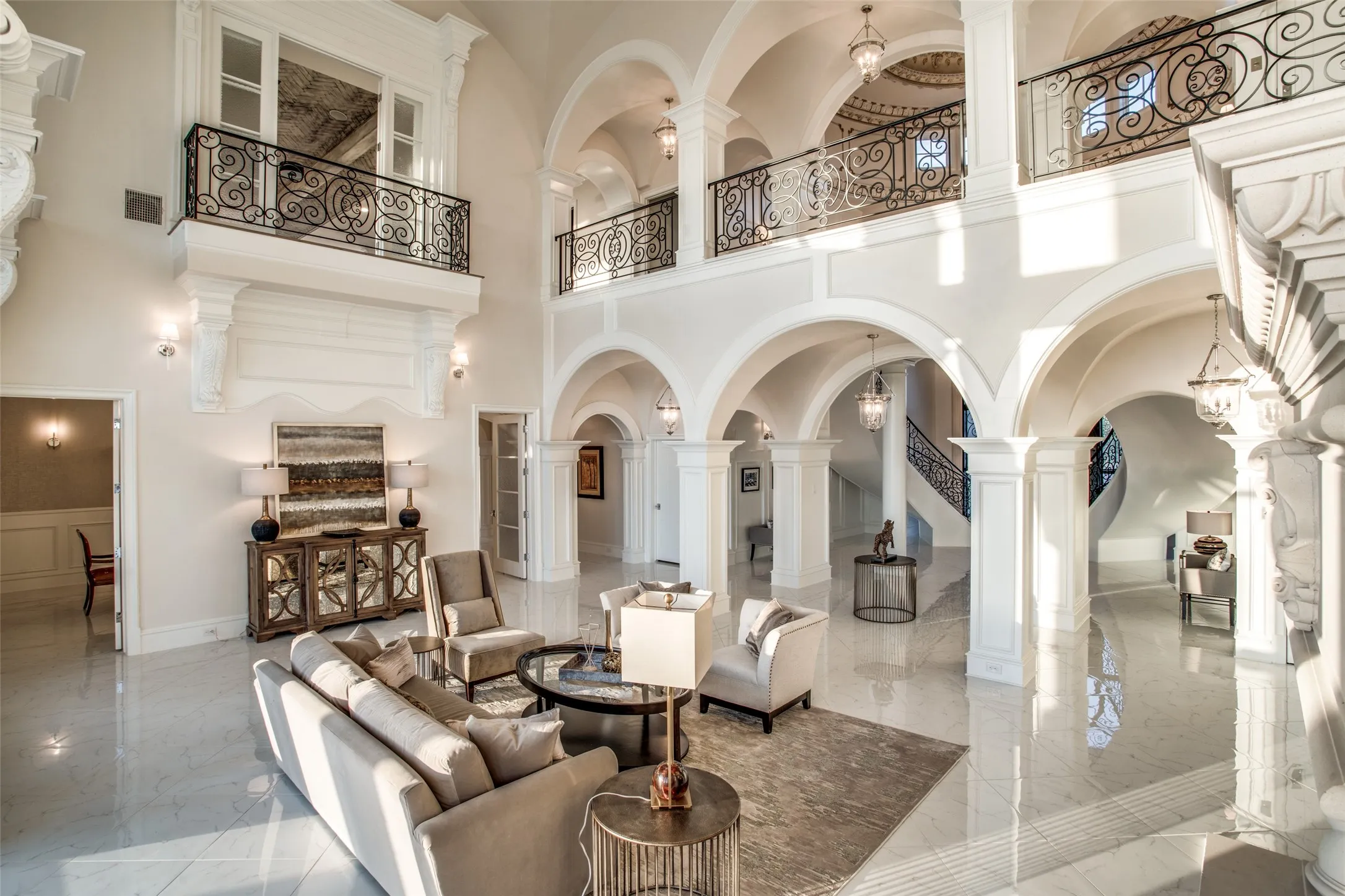 The grand formal living room showcases the fine craftsmanship of the elegant arches and finishes through the stately mansion.