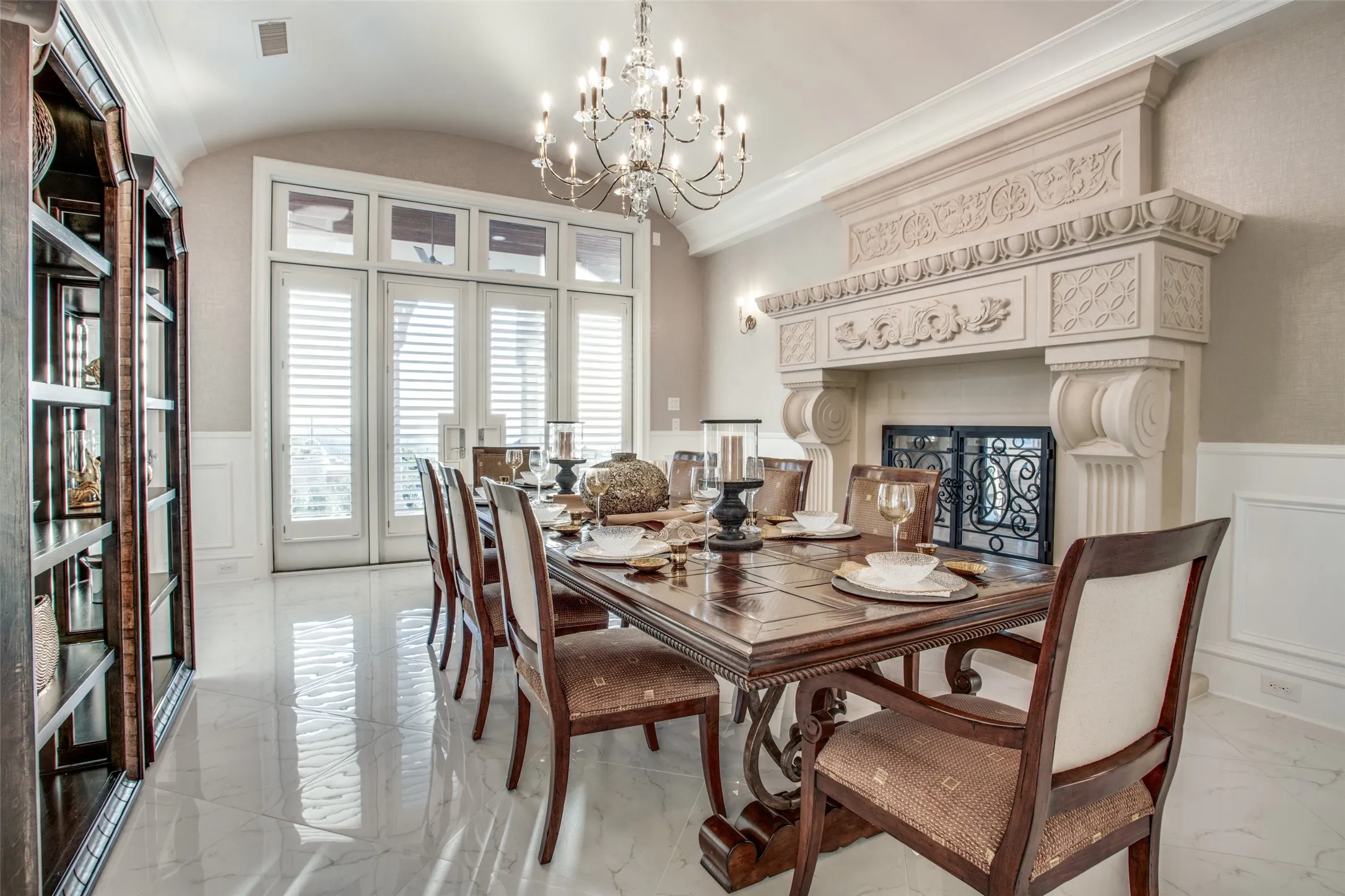 The formal dining room features built-in display cases, a see-through fireplace and patio doors opening to the resort style pool and spectacular views!