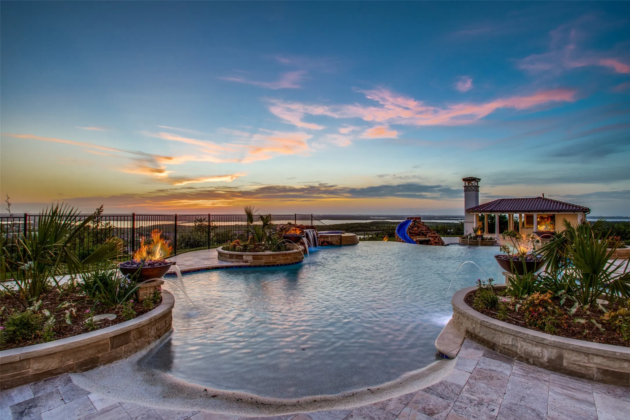 Incredible private sunsets await!  The resort-style pool features fire sconces, impeccable landscaping, waterfalls and grottos!