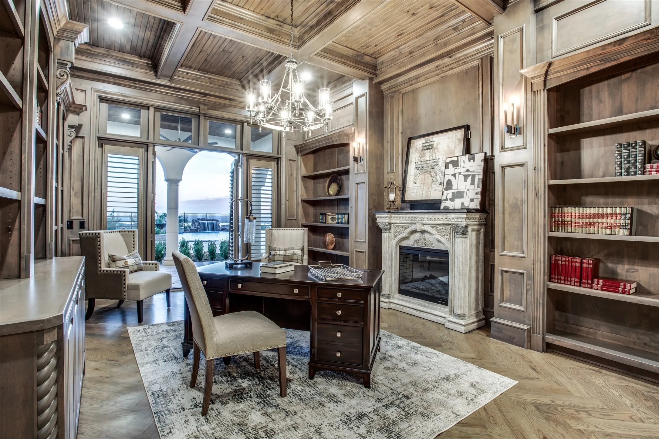 Housed in the primary suite wing, the maplewood office features built-in shelving, a cozy fireplace and patio doors opening to the resort style pool and spectacular views.  Hidden in the walls is a secluded safe room!