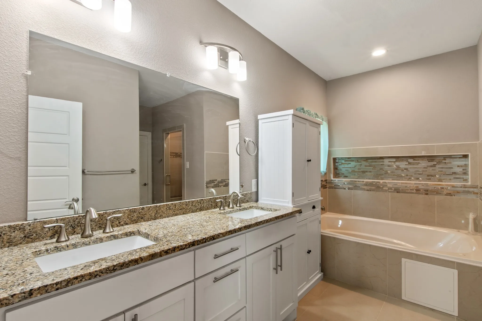 Primary bathroom with dual vanities