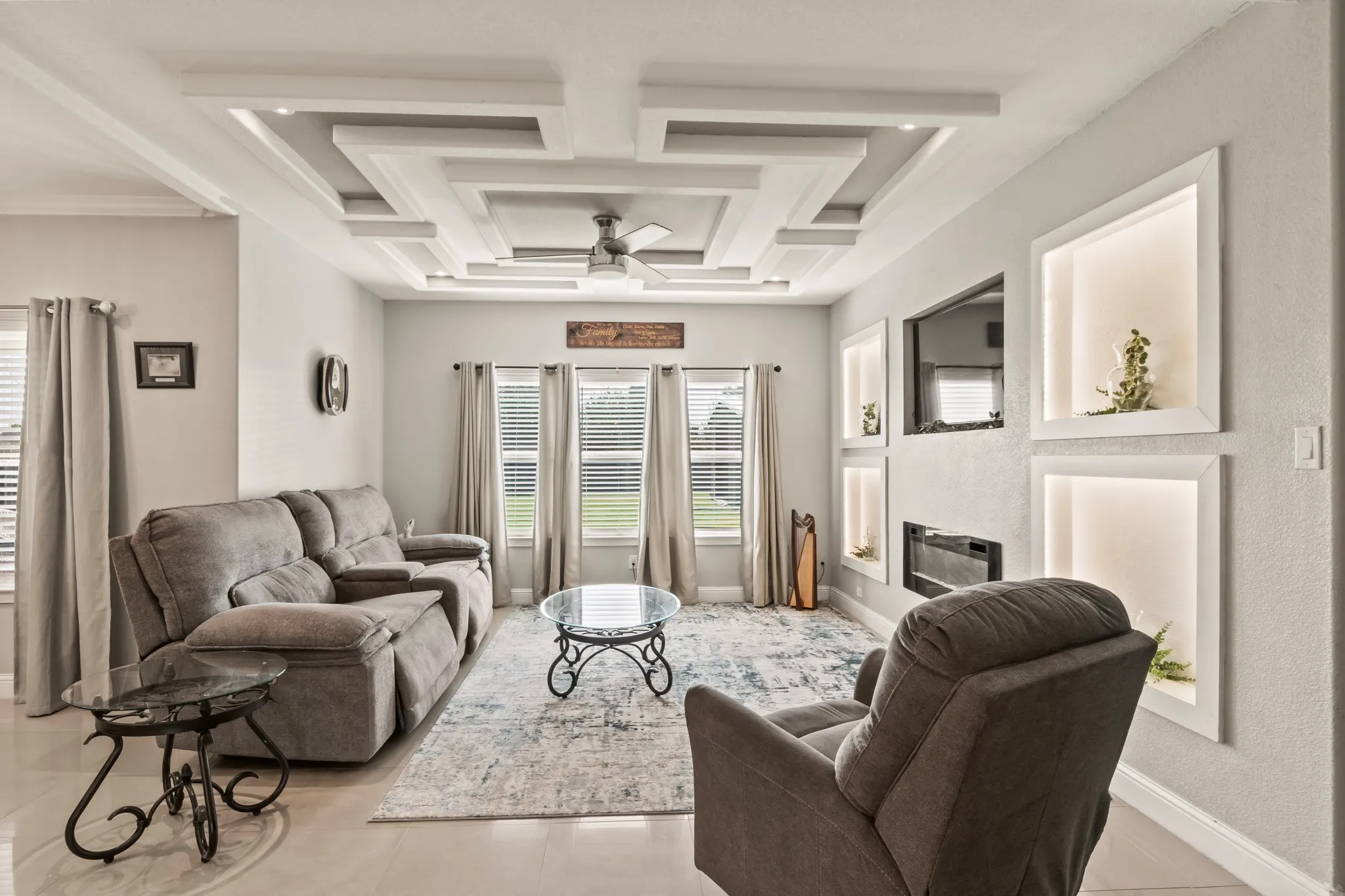 Living room with large windows overlooking the backyard