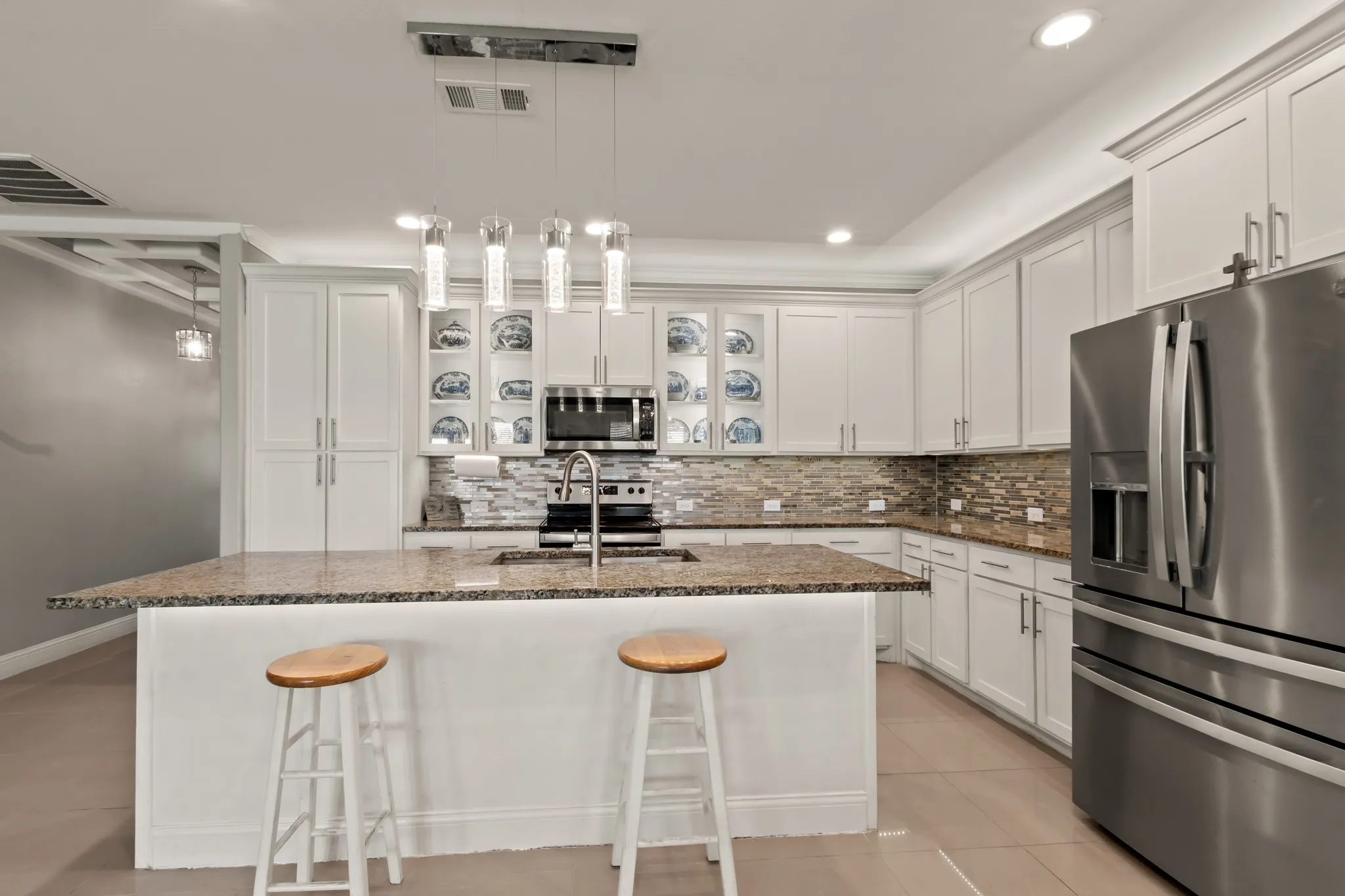 Kitchen with ample cabinetry, generous counter space, and bar seating