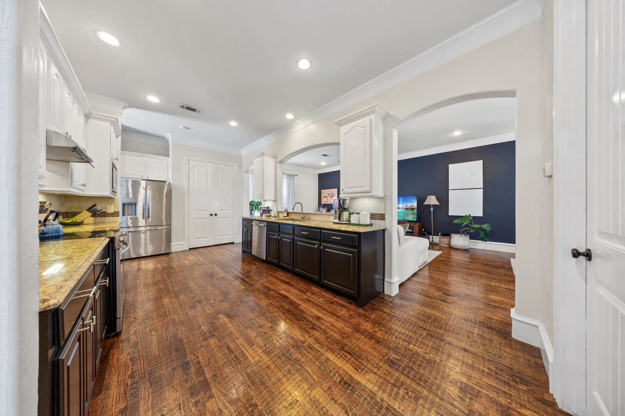 Kitchen featuring wood-finish flooring, recessed lighting, and a dual-tone cabinetry design