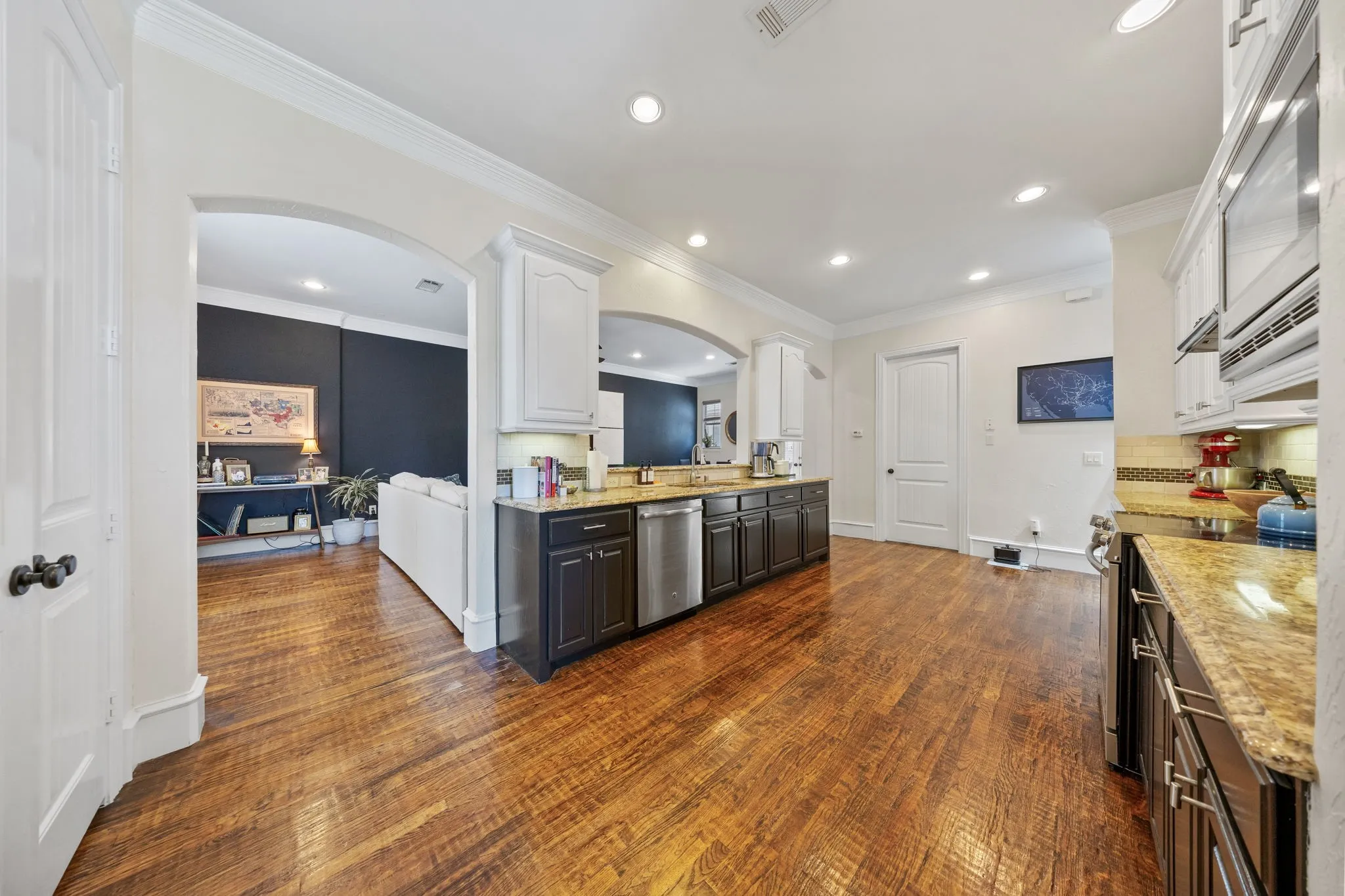Gourmet kitchen featuring wood-finish flooring, recessed lighting, and granite countertops