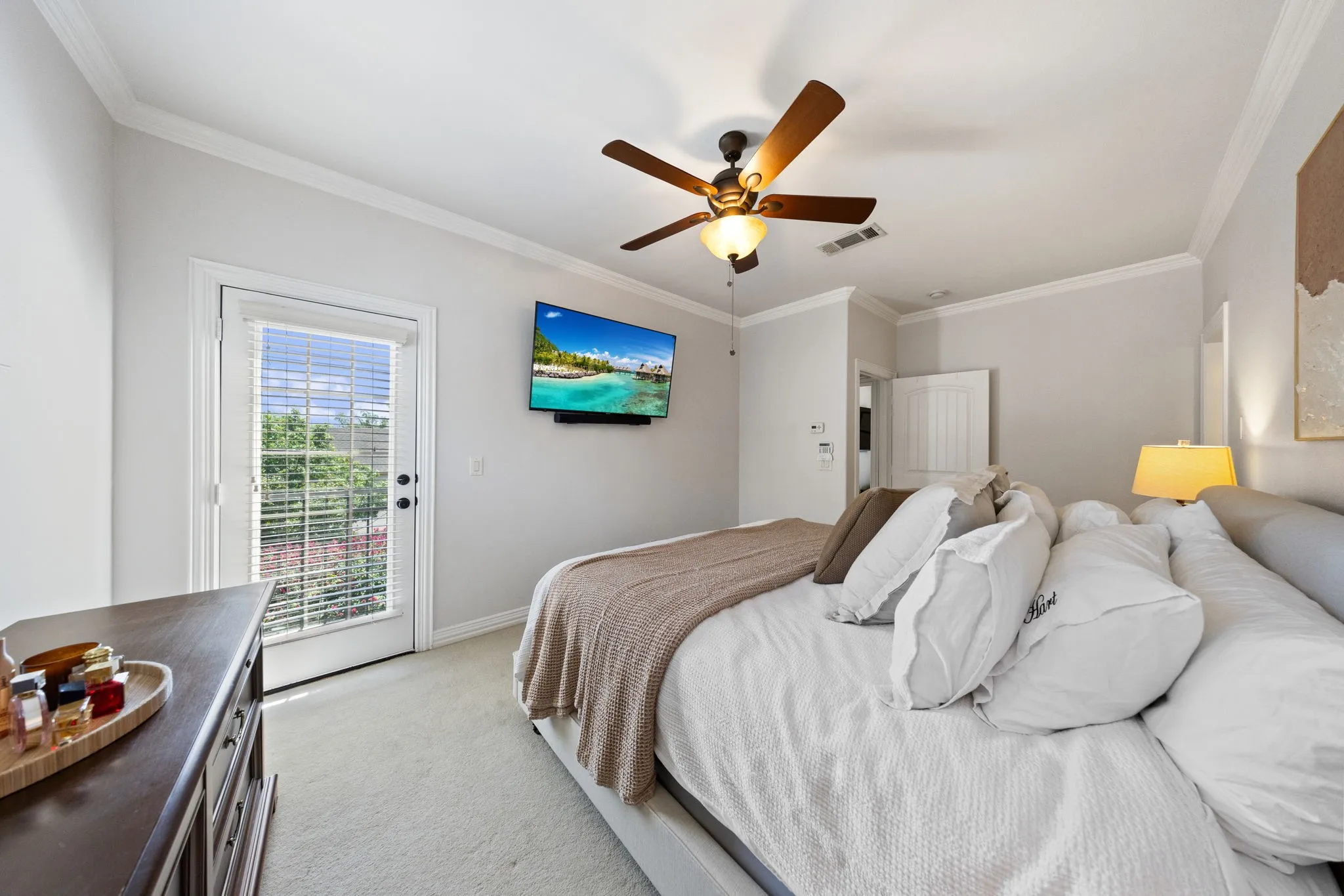 Bedroom featuring crown molding, a ceiling fan with integrated lighting, recessed lighting, and an exterior door with integrated blinds