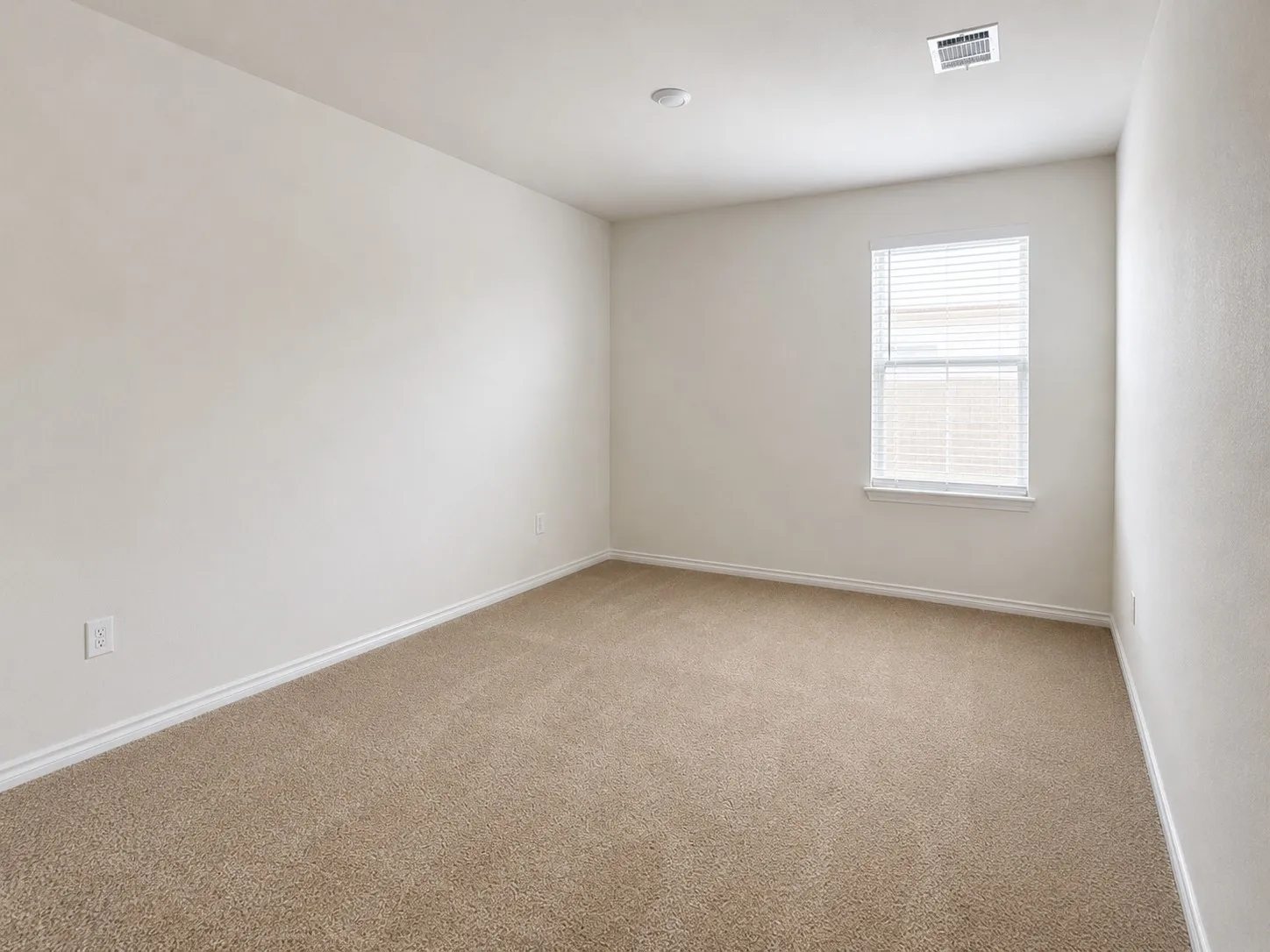 Carpeted room with a single window featuring horizontal blinds