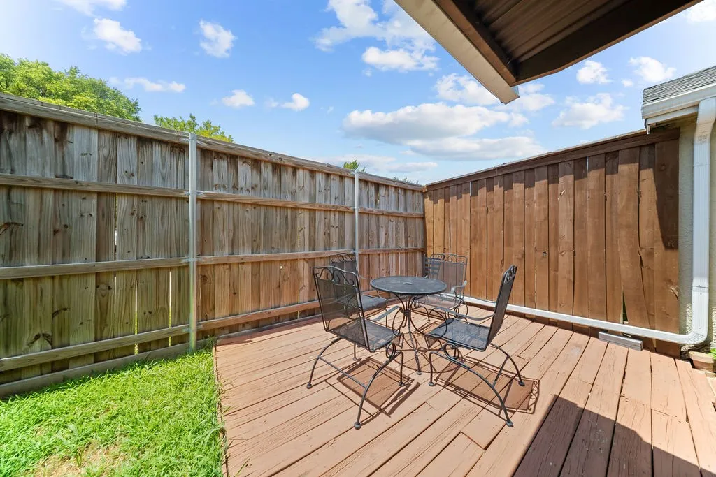 Private outdoor deck area featuring wood decking and perimeter privacy fencing