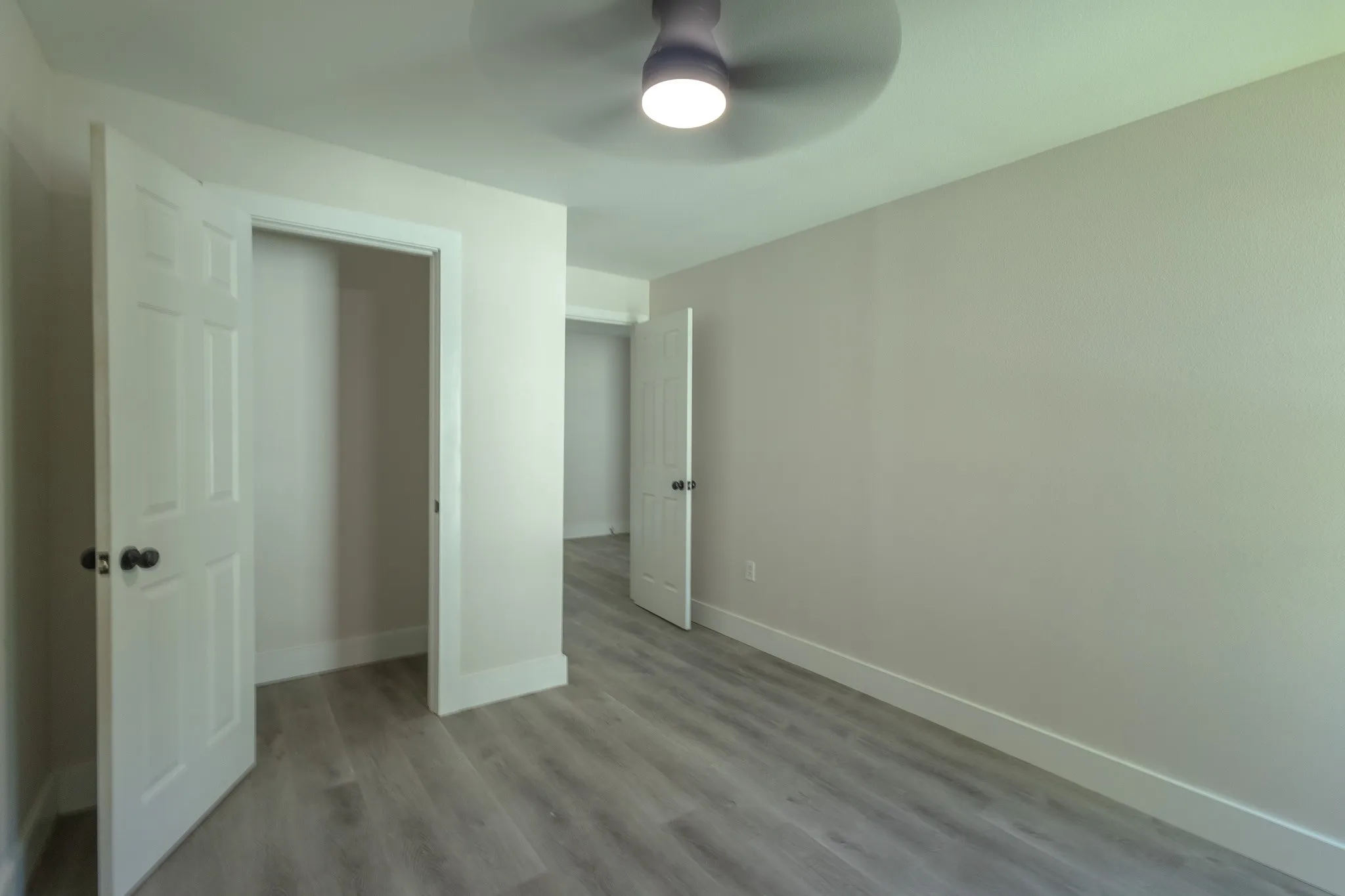 Neutral wall tones with wood-finish flooring