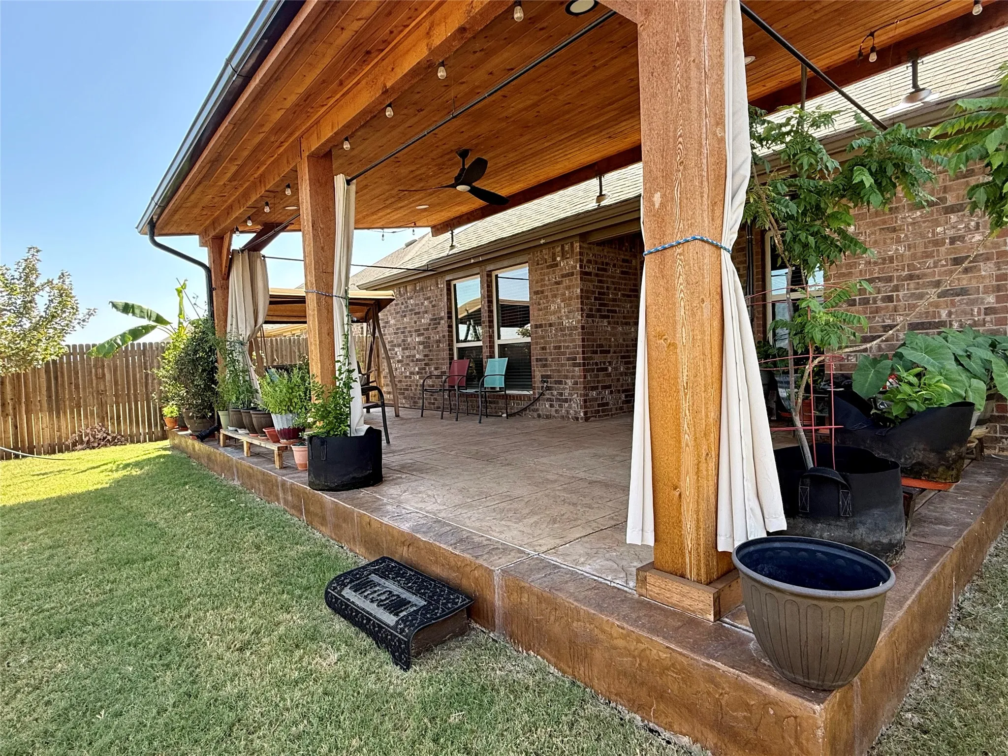 Expansive covered patio featuring a wood-plank ceiling, recessed lighting, ceiling fan, and concrete flooring