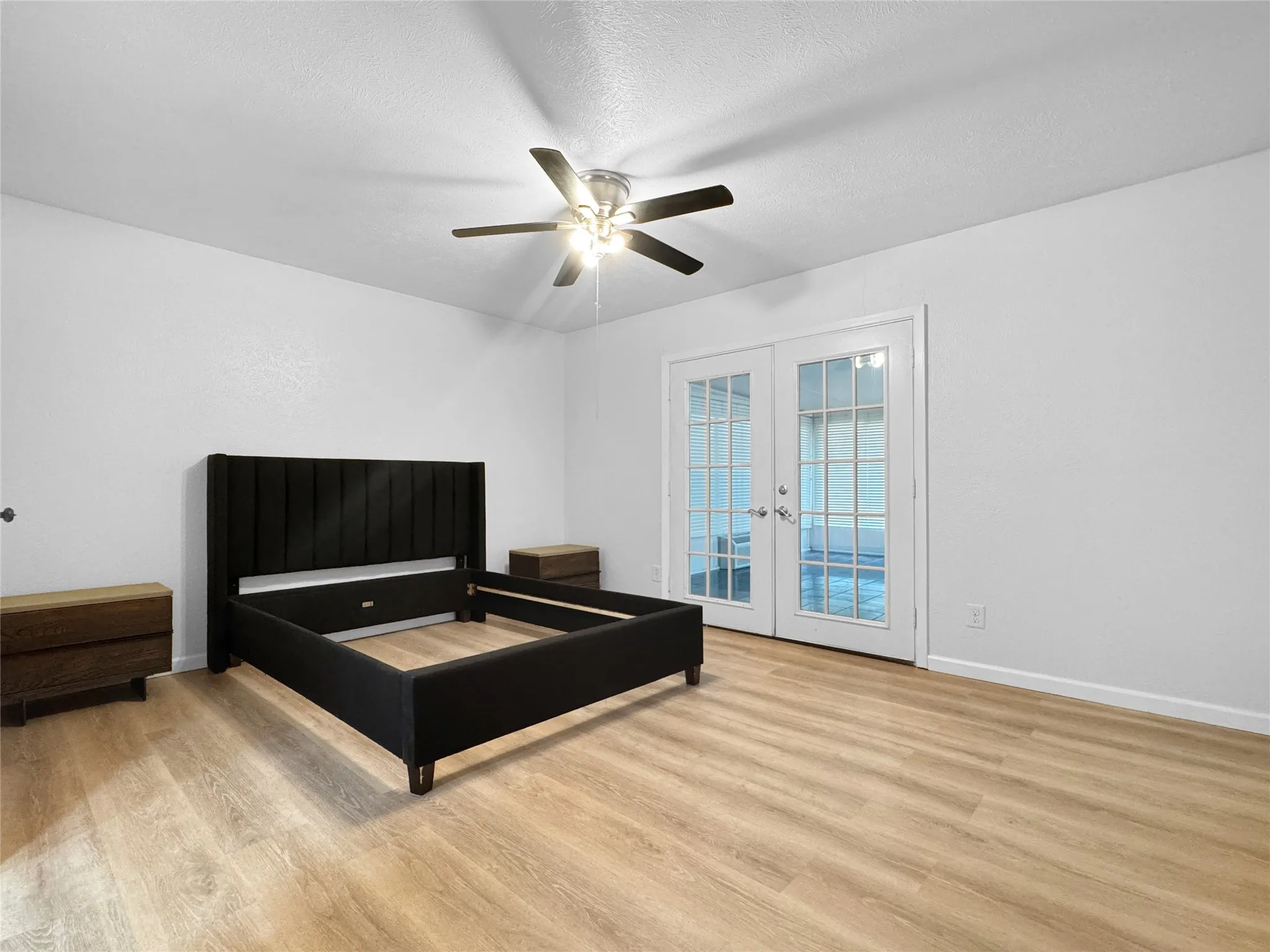 Light wood-finish flooring complements the neutral wall color