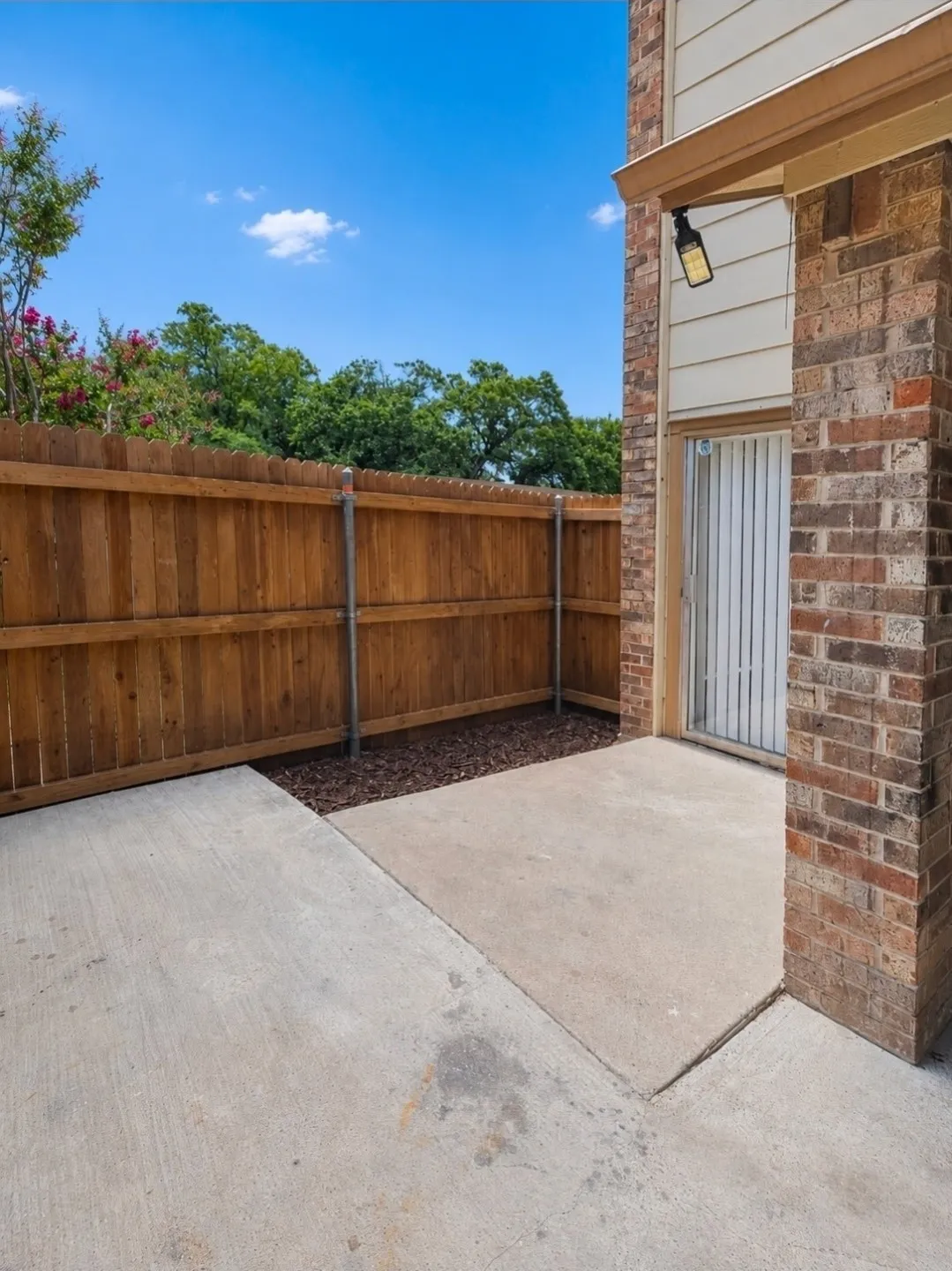 Private patio area featuring concrete flooring