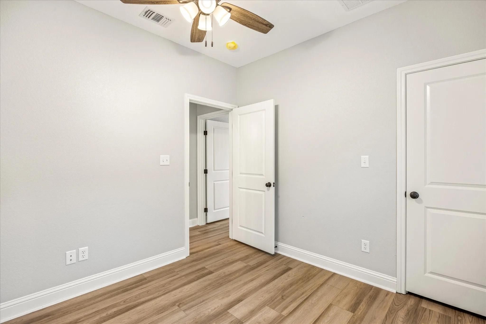 Light-toned walls with wood-finish flooring