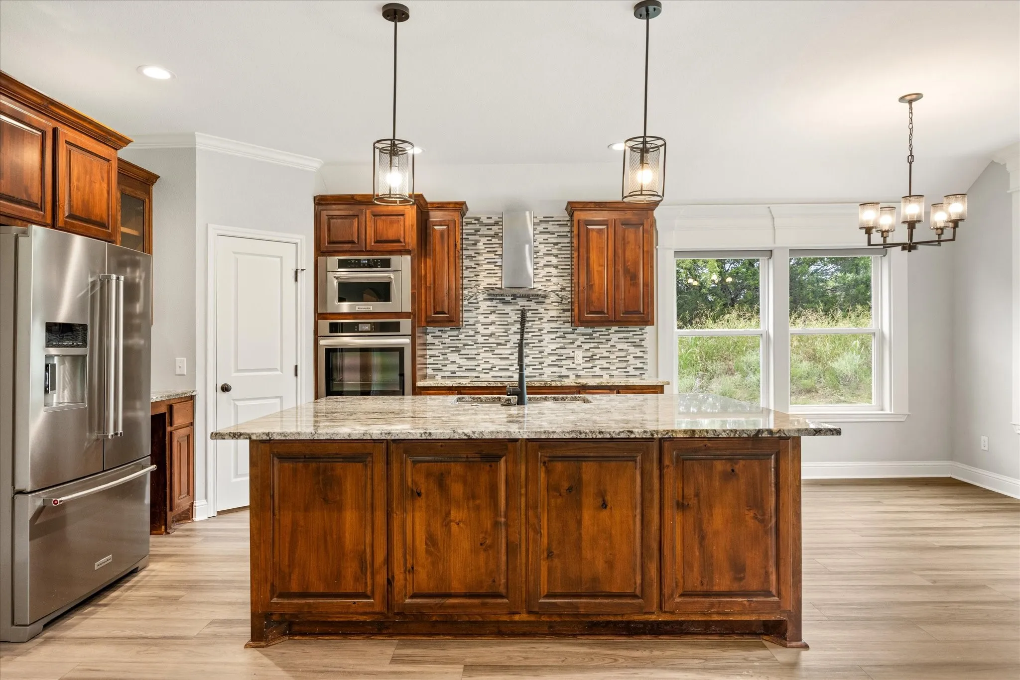 Kitchen featuring a central island with a stone countertop and wood cabinetry