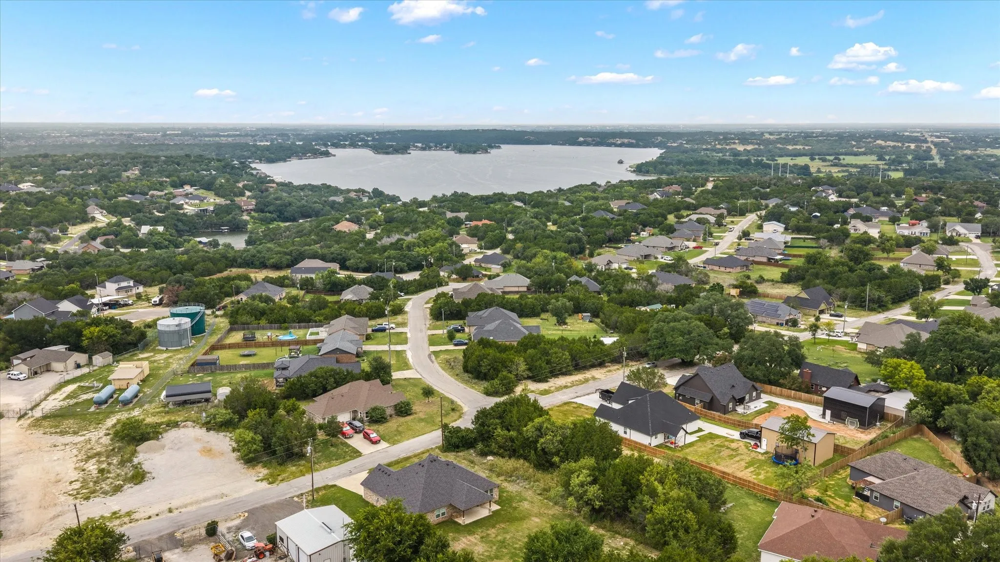 Expansive aerial view showcasing a residential area with a prominent body of water in the background