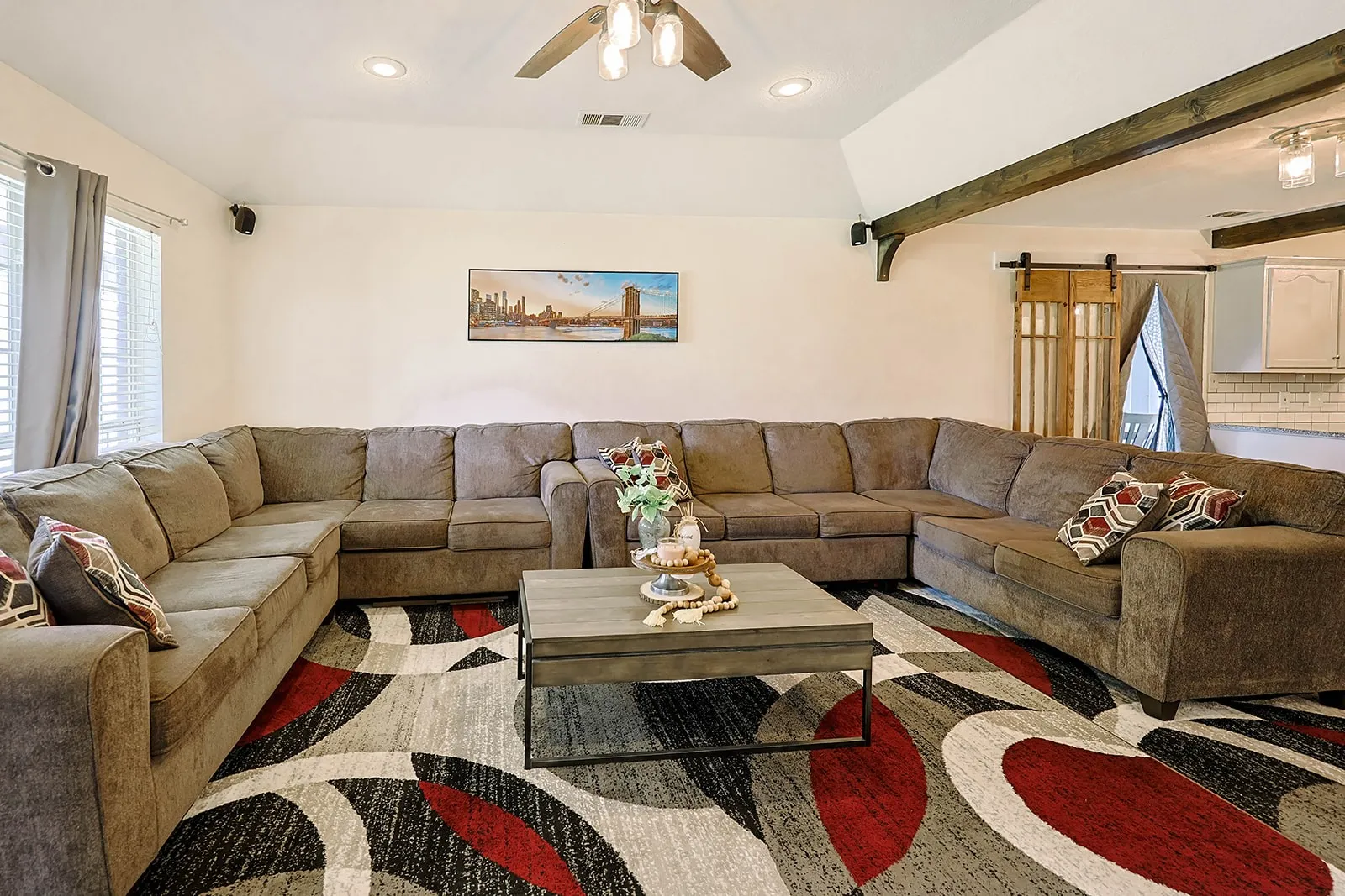 Vaulted ceilings with exposed wood beams define this living area