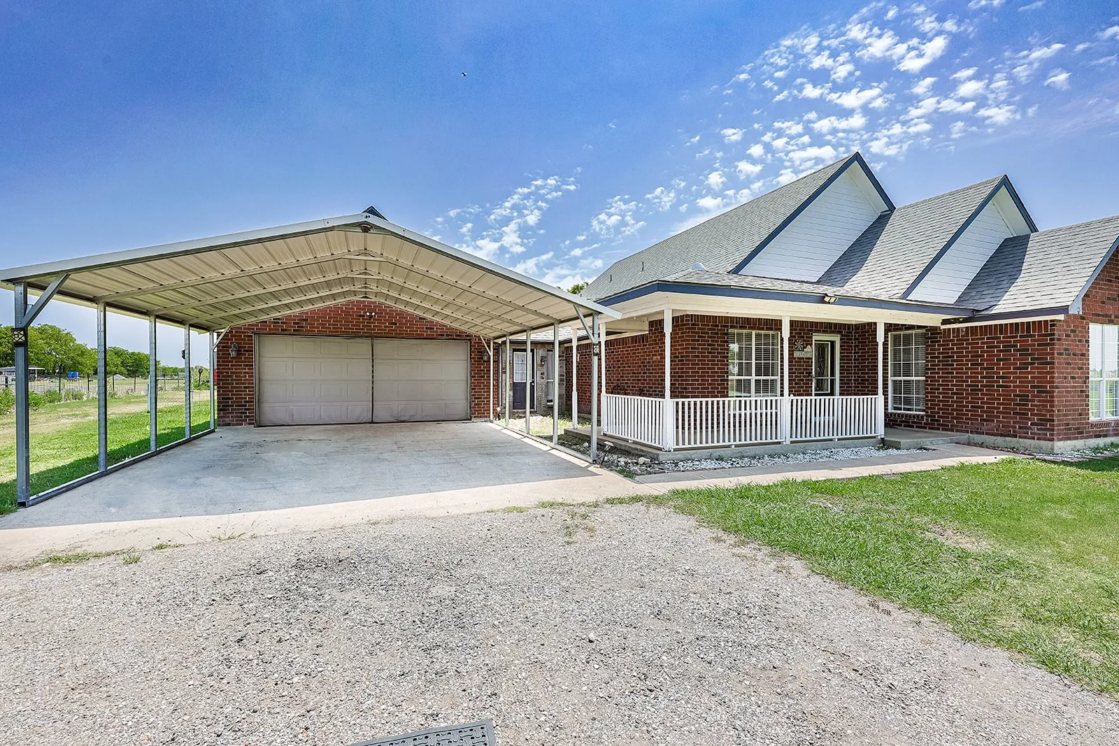 Brick exterior with a covered front porch featuring white railings