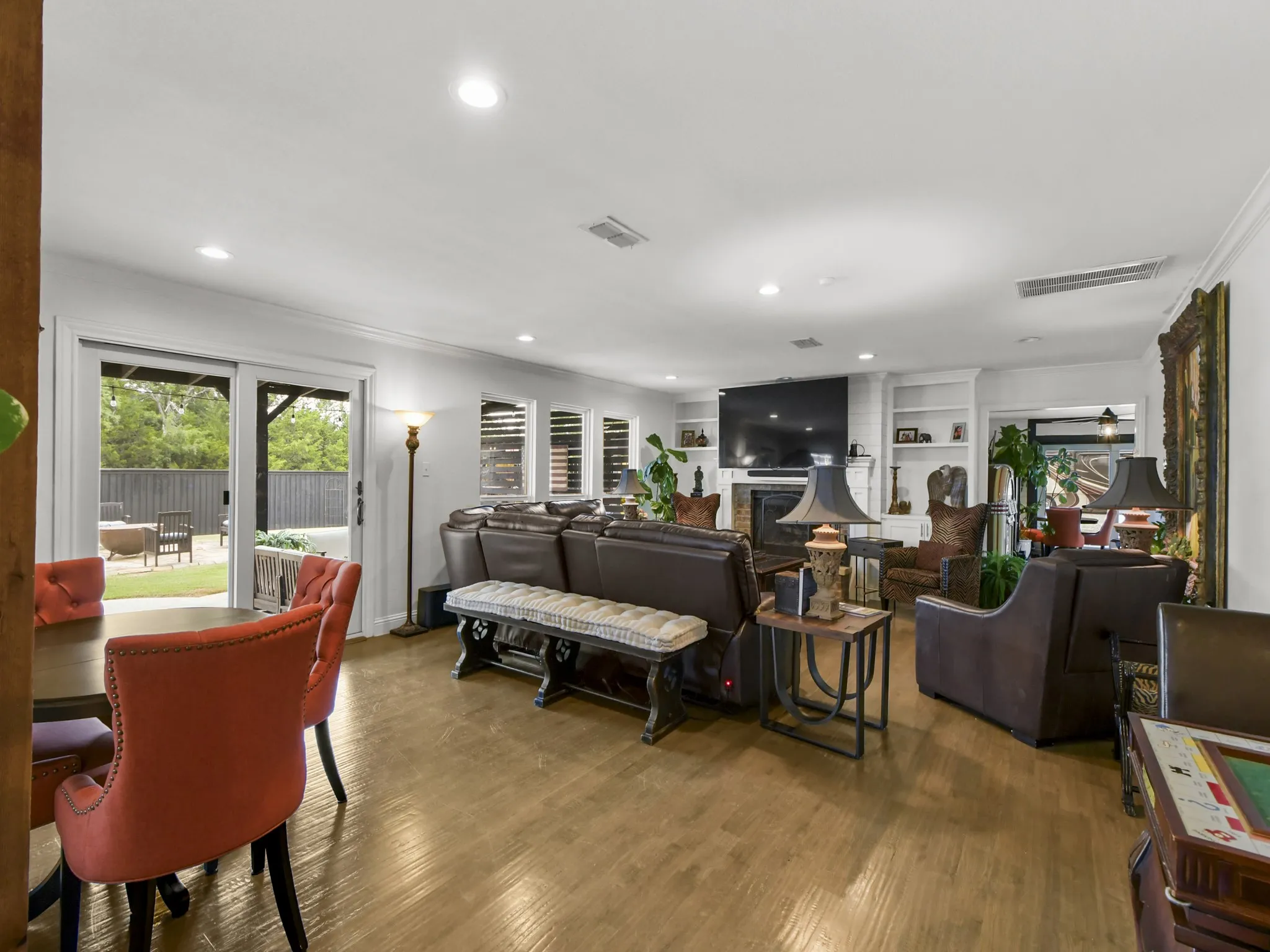 Spacious living area featuring wood-finish flooring and recessed lighting