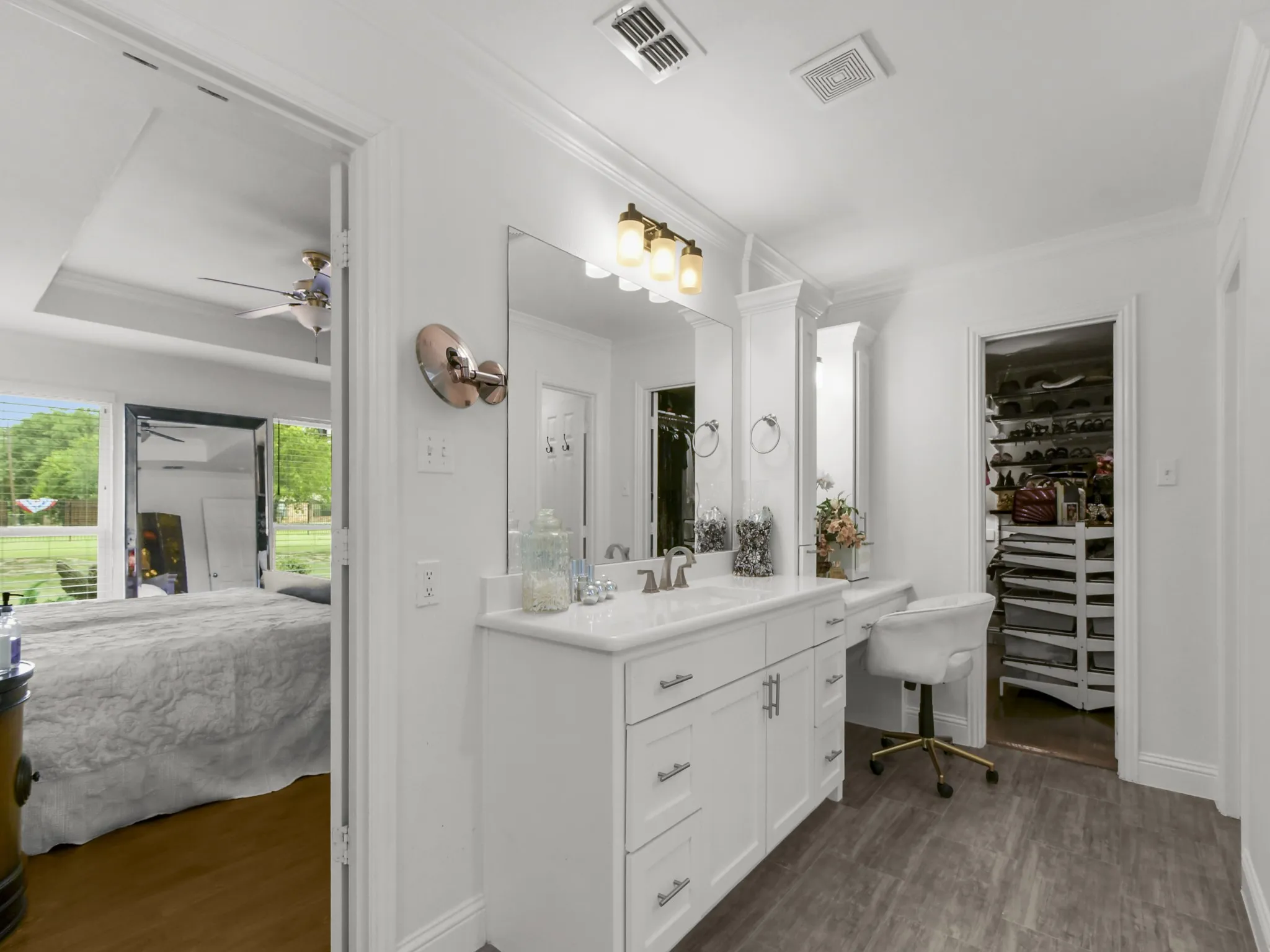 Double vanity with white cabinetry, integrated sinks, and polished chrome fixtures