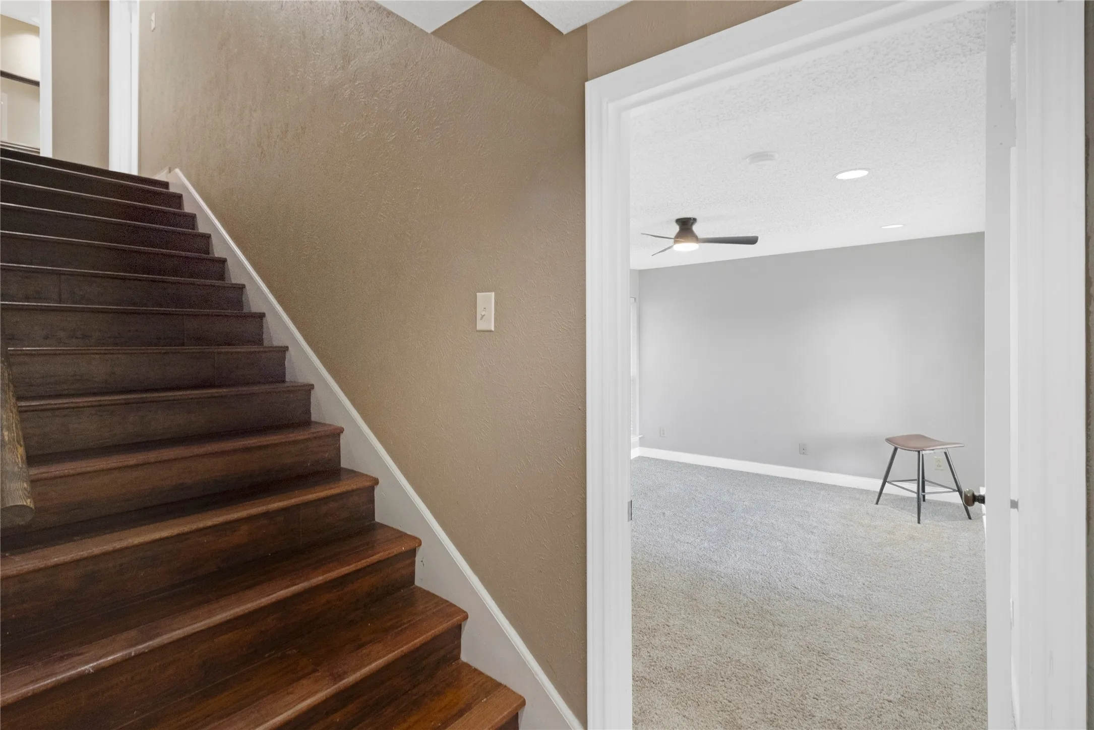 Wood-finish staircase with white risers and trim