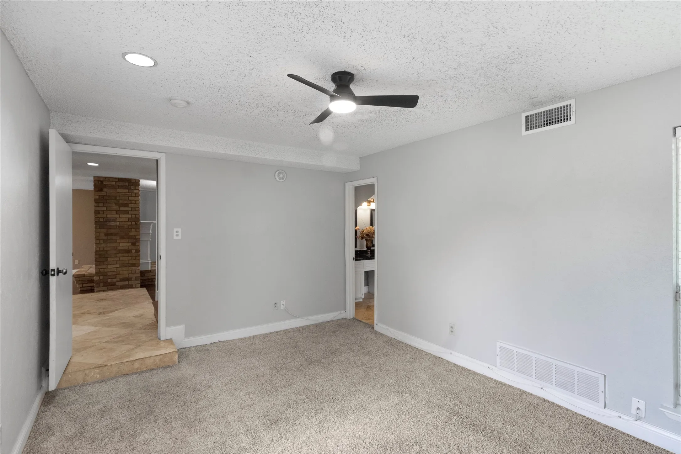 Carpeted room with recessed lighting, ceiling fan, and light gray walls