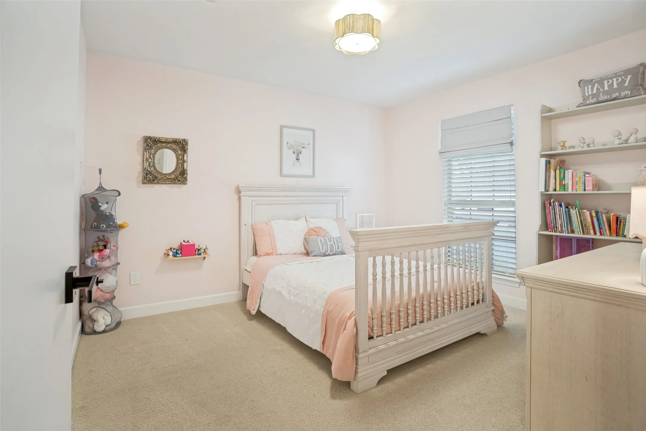 Bedroom featuring neutral carpet flooring and a built-in shelving unit