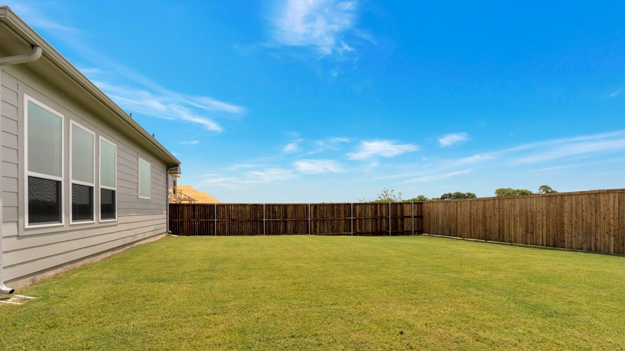 View of fenced backyard