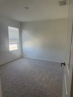 Recessed ceiling lighting, wall-to-wall carpeting, single window with blinds, and paneled interior door with dark hardware