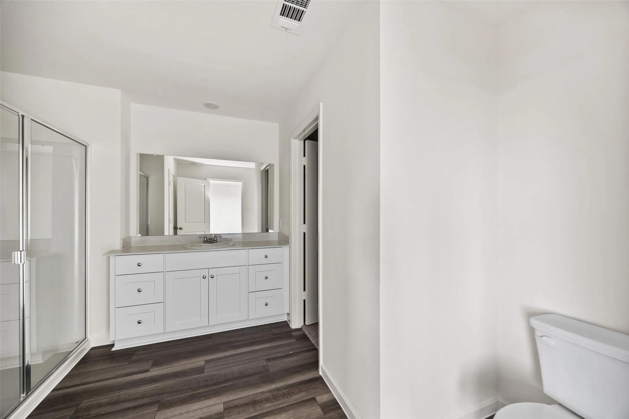 White vanity with double sinks and a light-colored countertop
