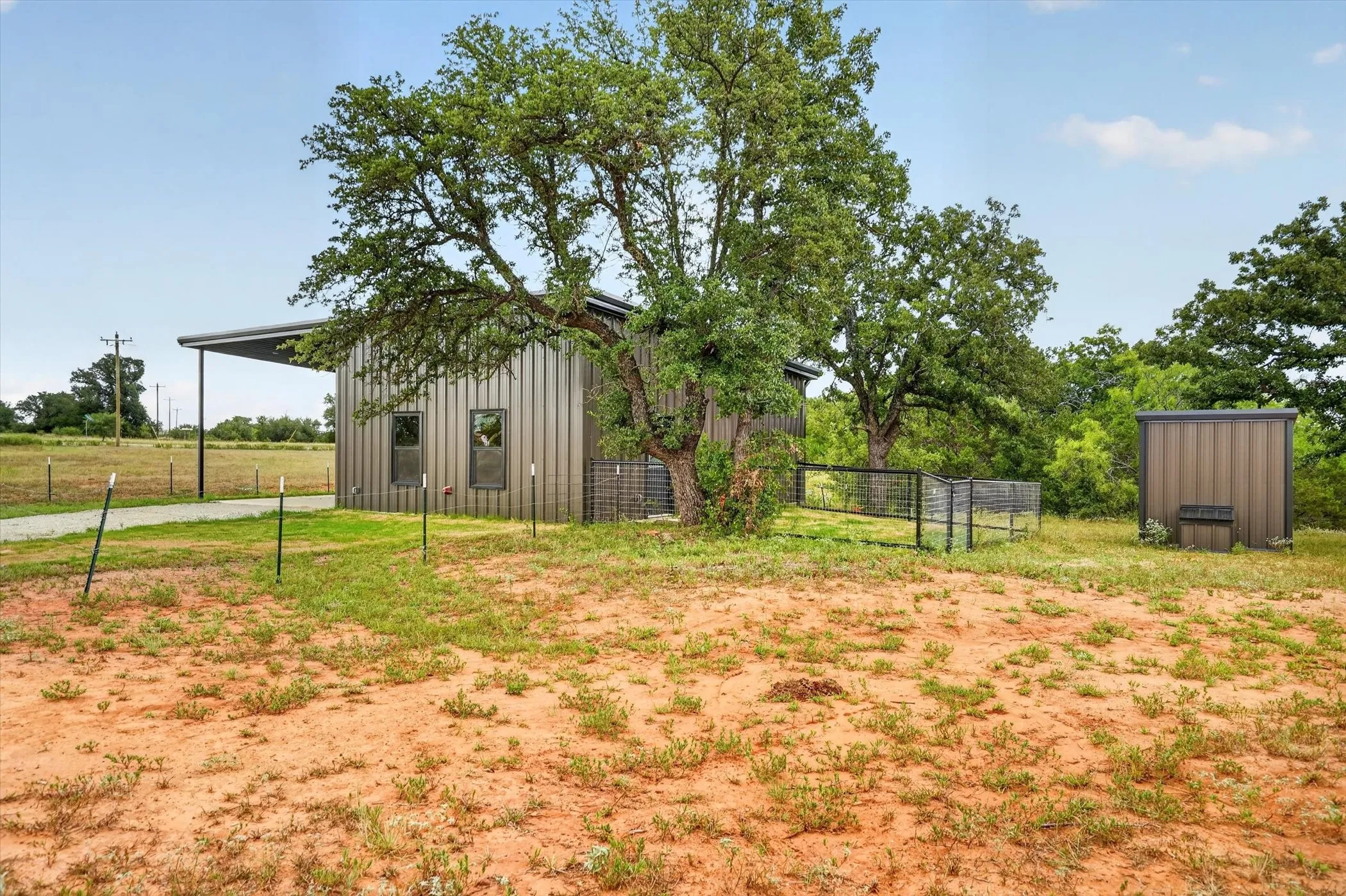 Metal-clad structure with a covered carport
