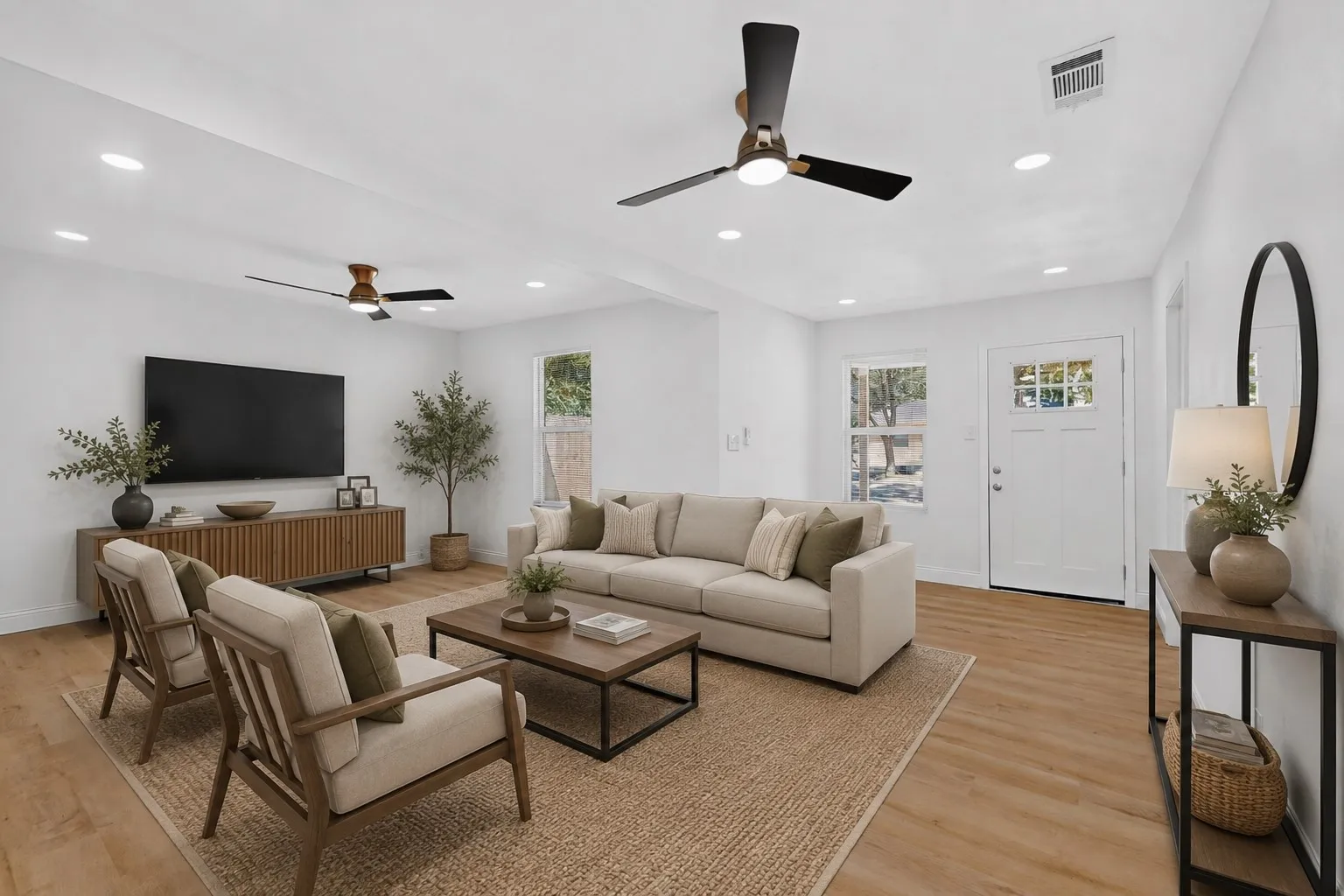 Virtually staged bright living area featuring wood-finish flooring, recessed lighting, and two ceiling fans