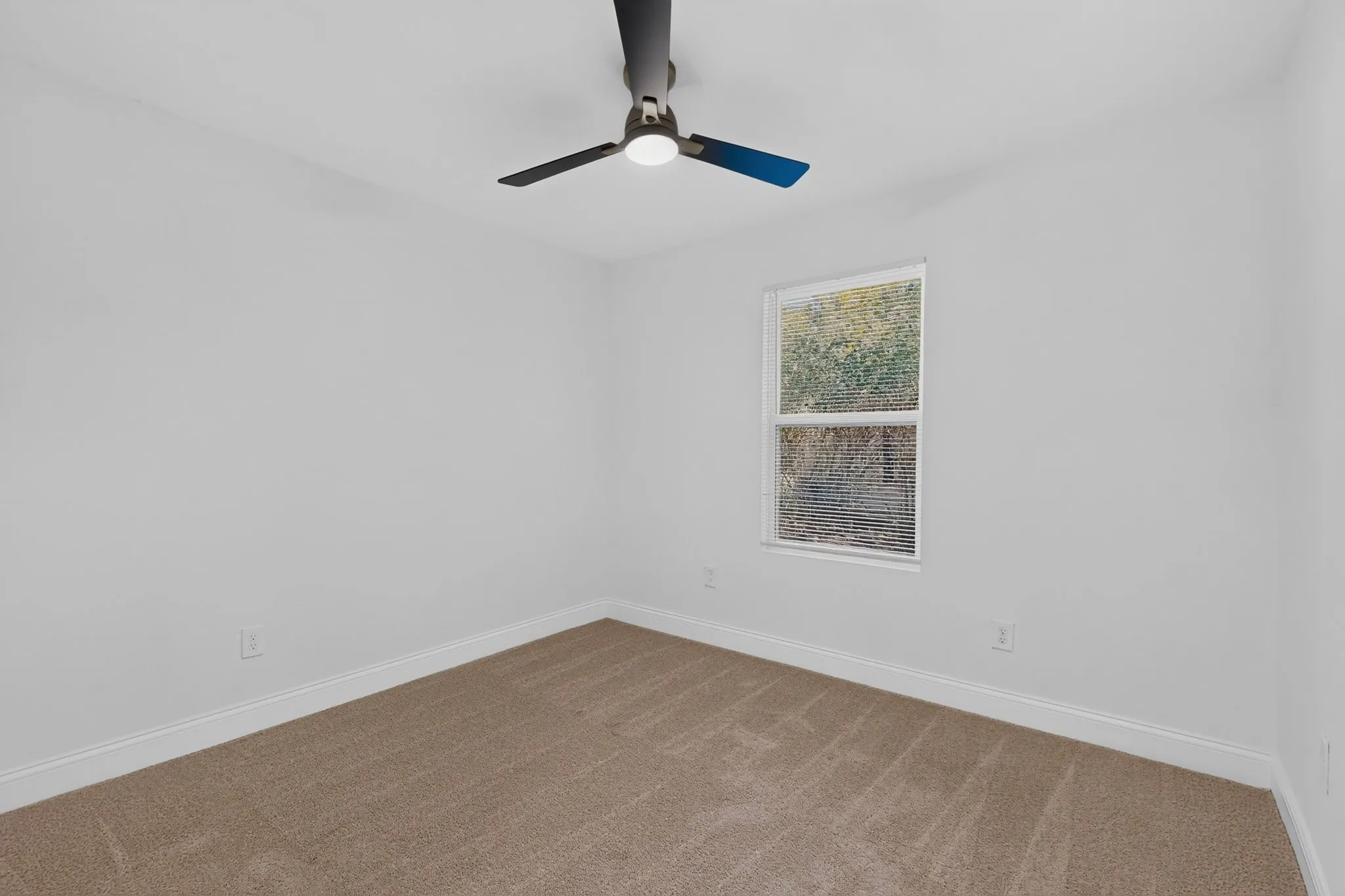 Bedroom 2 featuring a neutral carpet, white walls, and a modern ceiling fan with integrated lighting