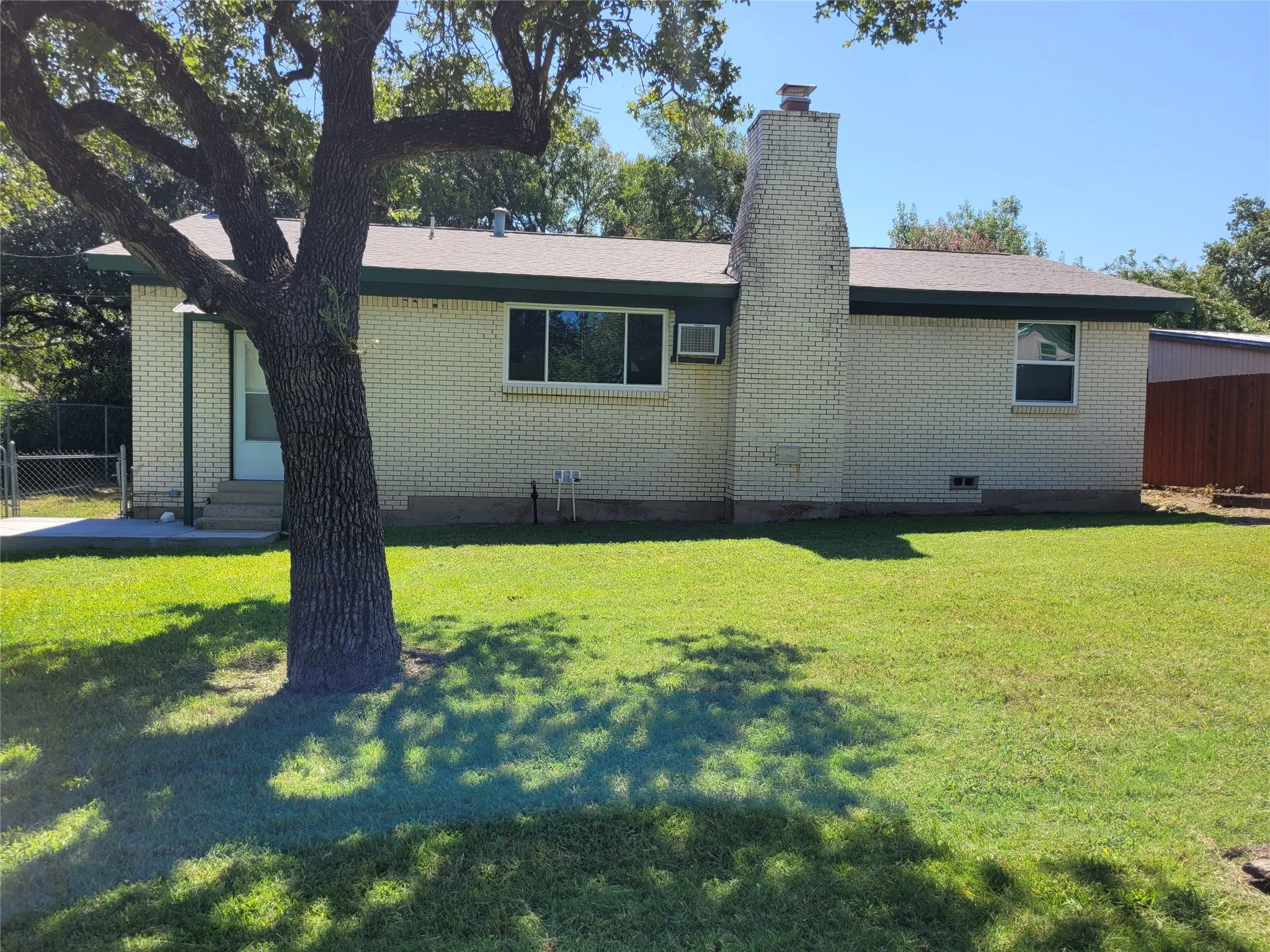 Rear view of home and concrete patio.