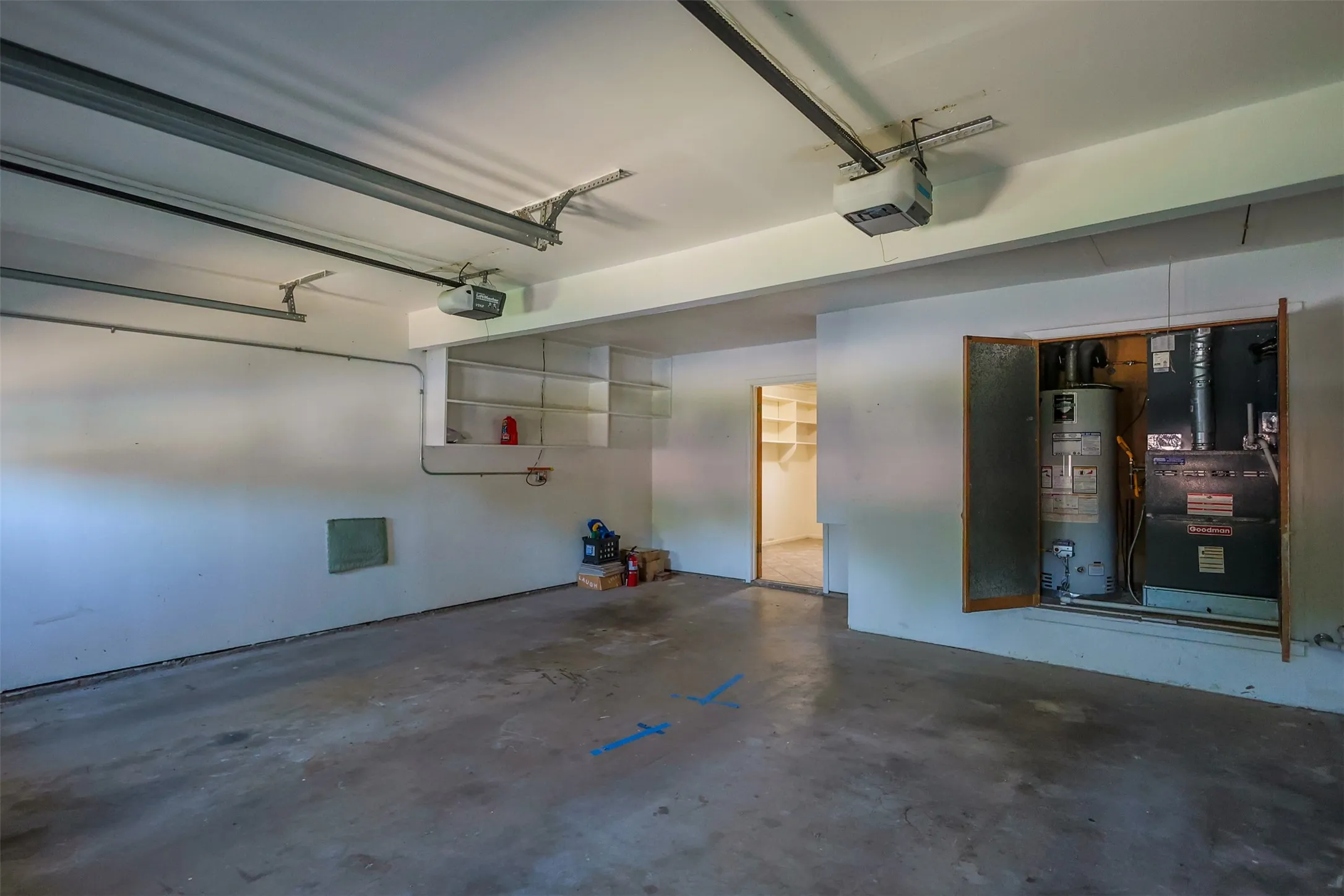 Spacious garage with exposed ceiling beams and durable concrete flooring