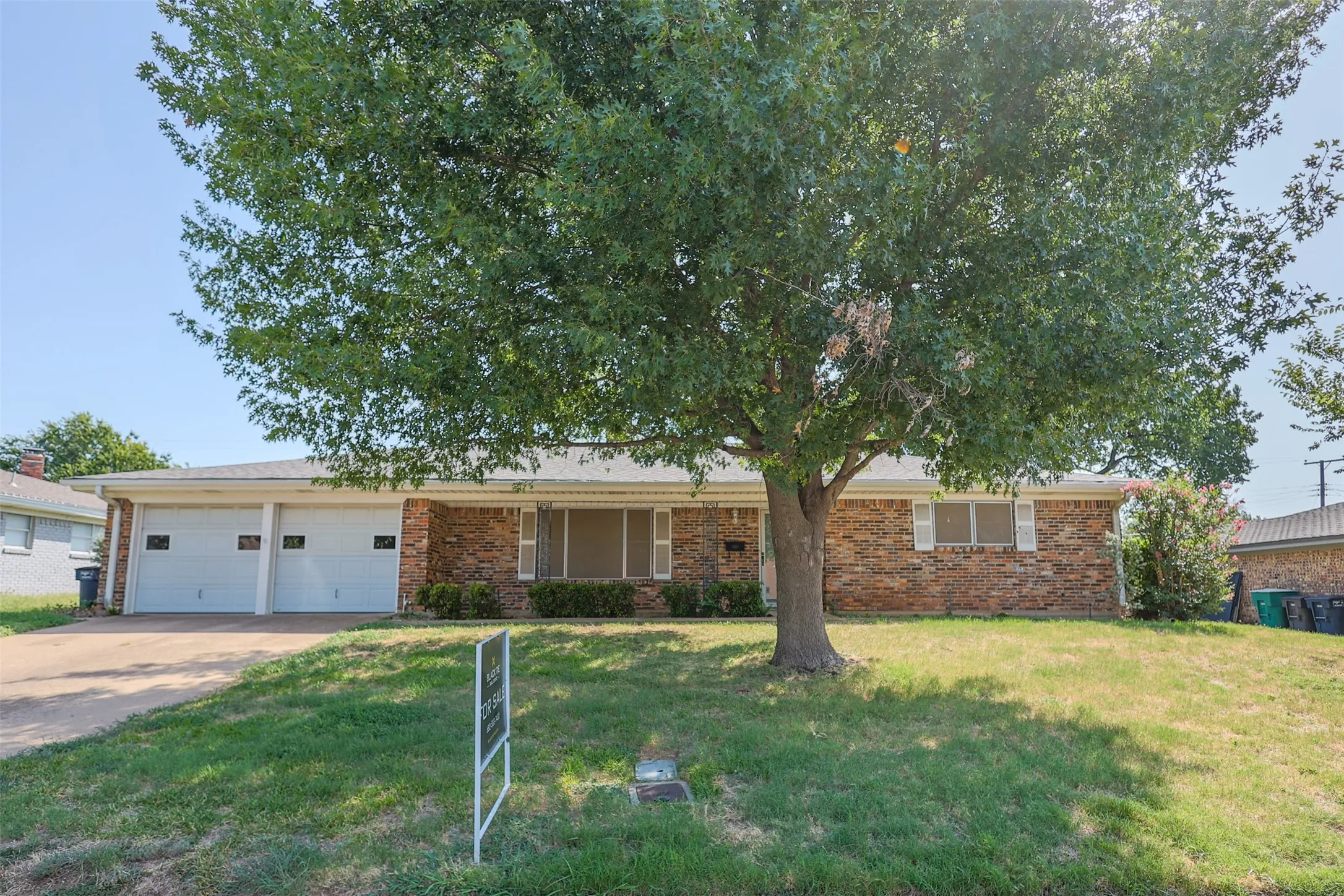 Brick exterior with a mature front yard tree